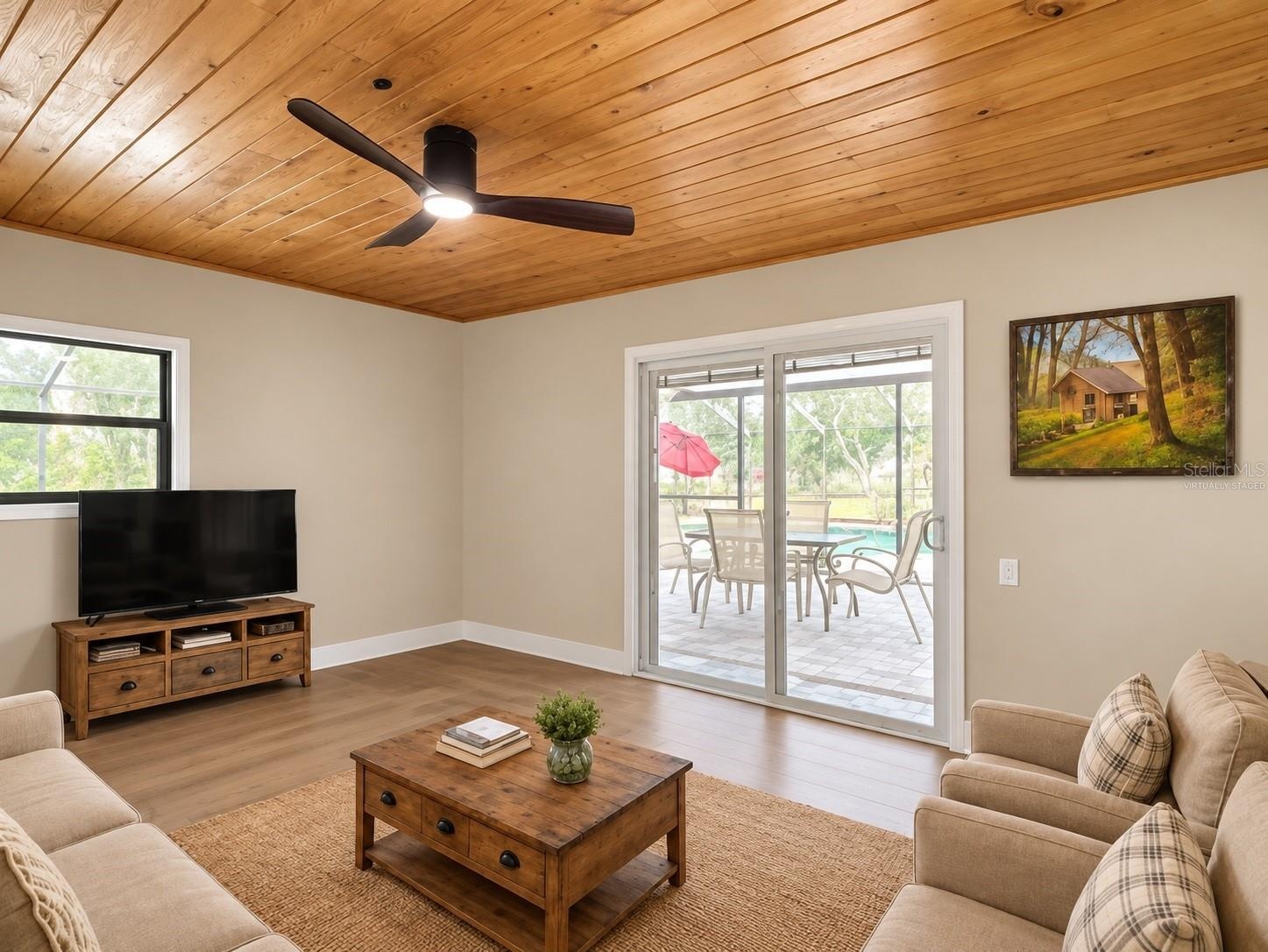 Virtually staged den area off pool area