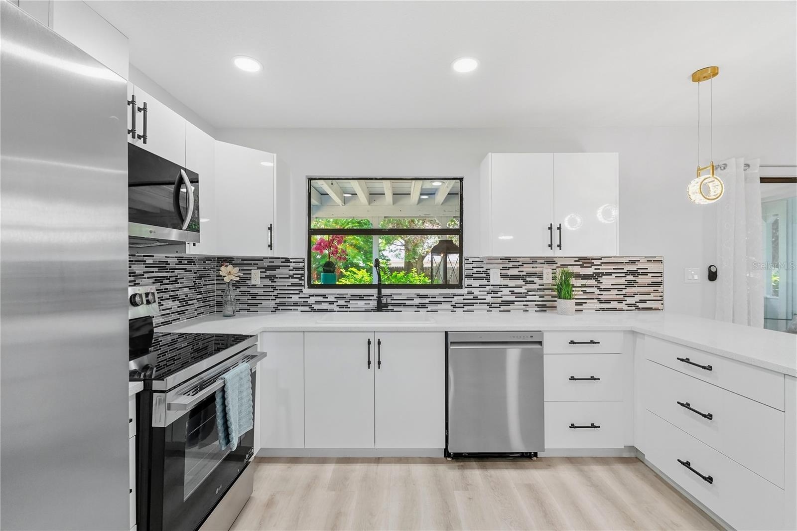 Quartz Countertops, European-Style Cabinetry w/ Soft-Close, New Appliances, Stunning Glass Backsplash.