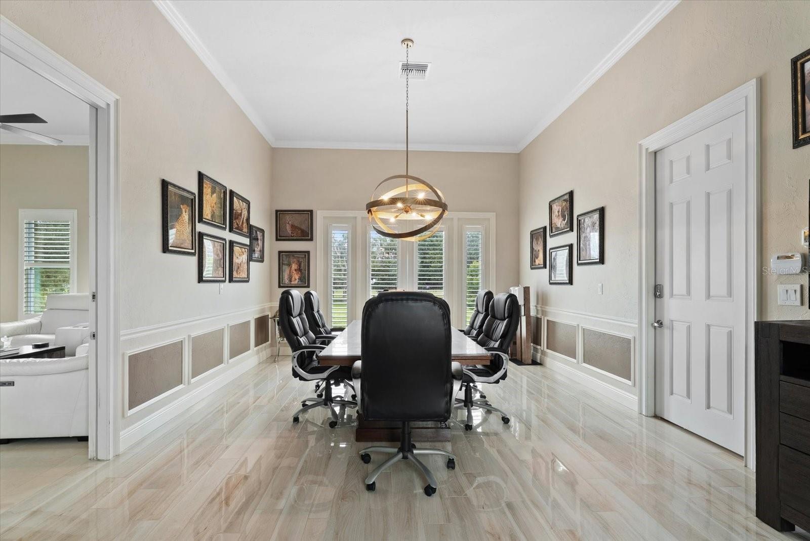 Just beyond the media room is a unique space - a full in-law suite/apartment that would serve many purposes. Thi first room is currently used as a con
