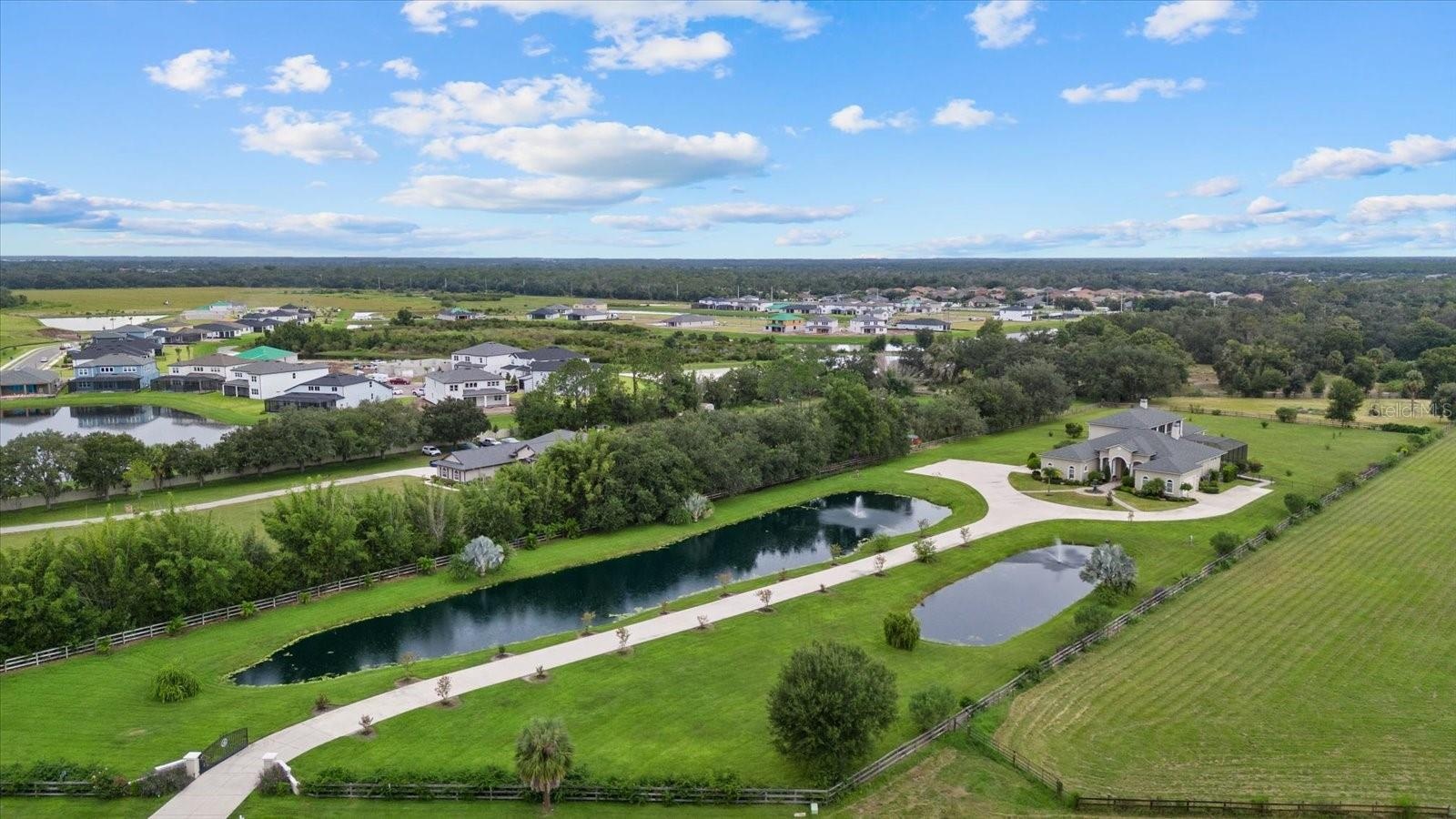 The drone photo gives a nice perspective of the long driveway and two ponds