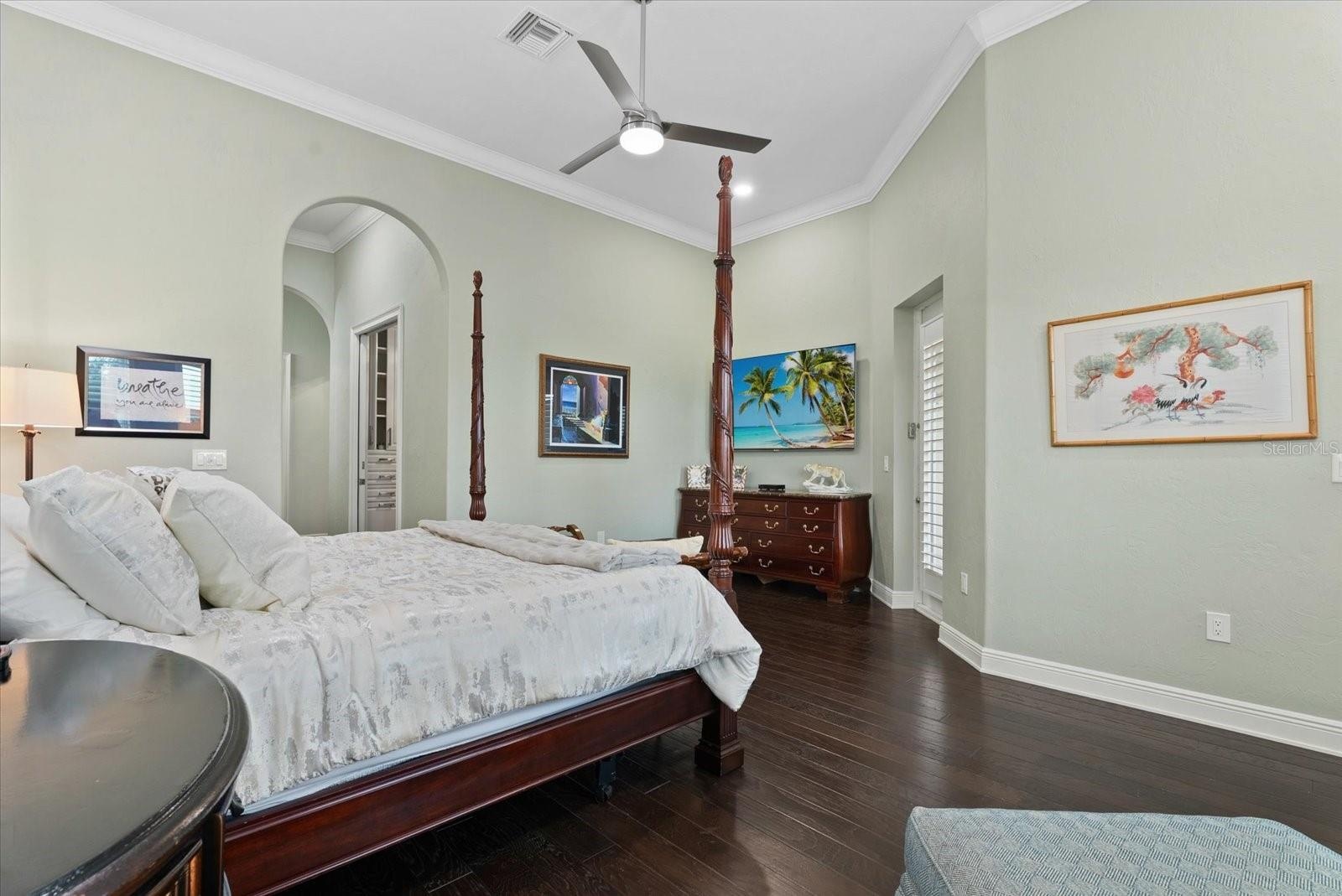 The hallway leading into the primarty suite features two walk-in closets