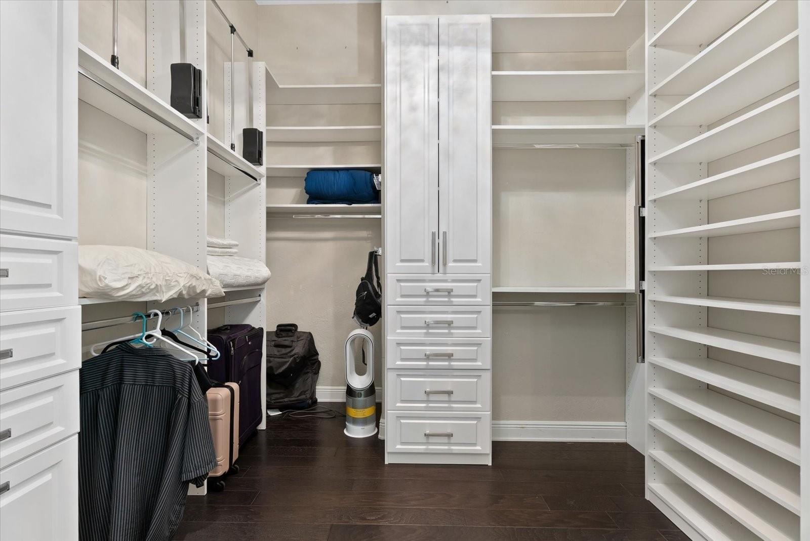The two walk-in closets feature custom cabinets and shelving
