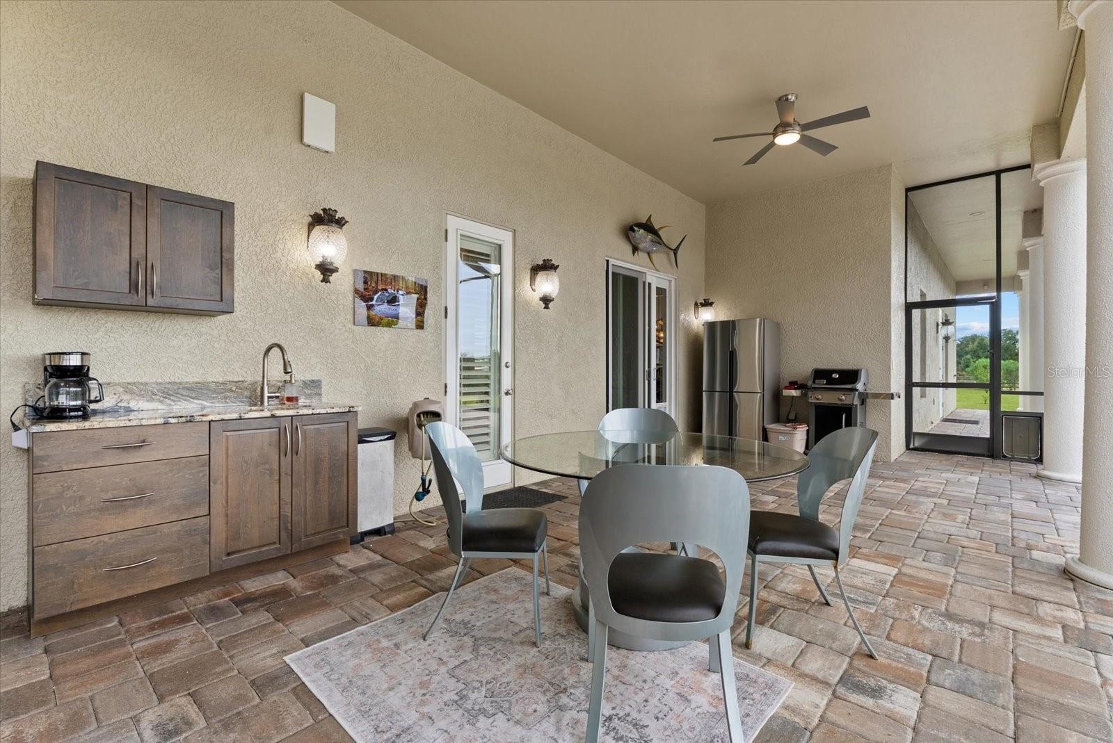The second outdoor lounge area is off the family room/kitchen area, and offers access to the half bath off the media room