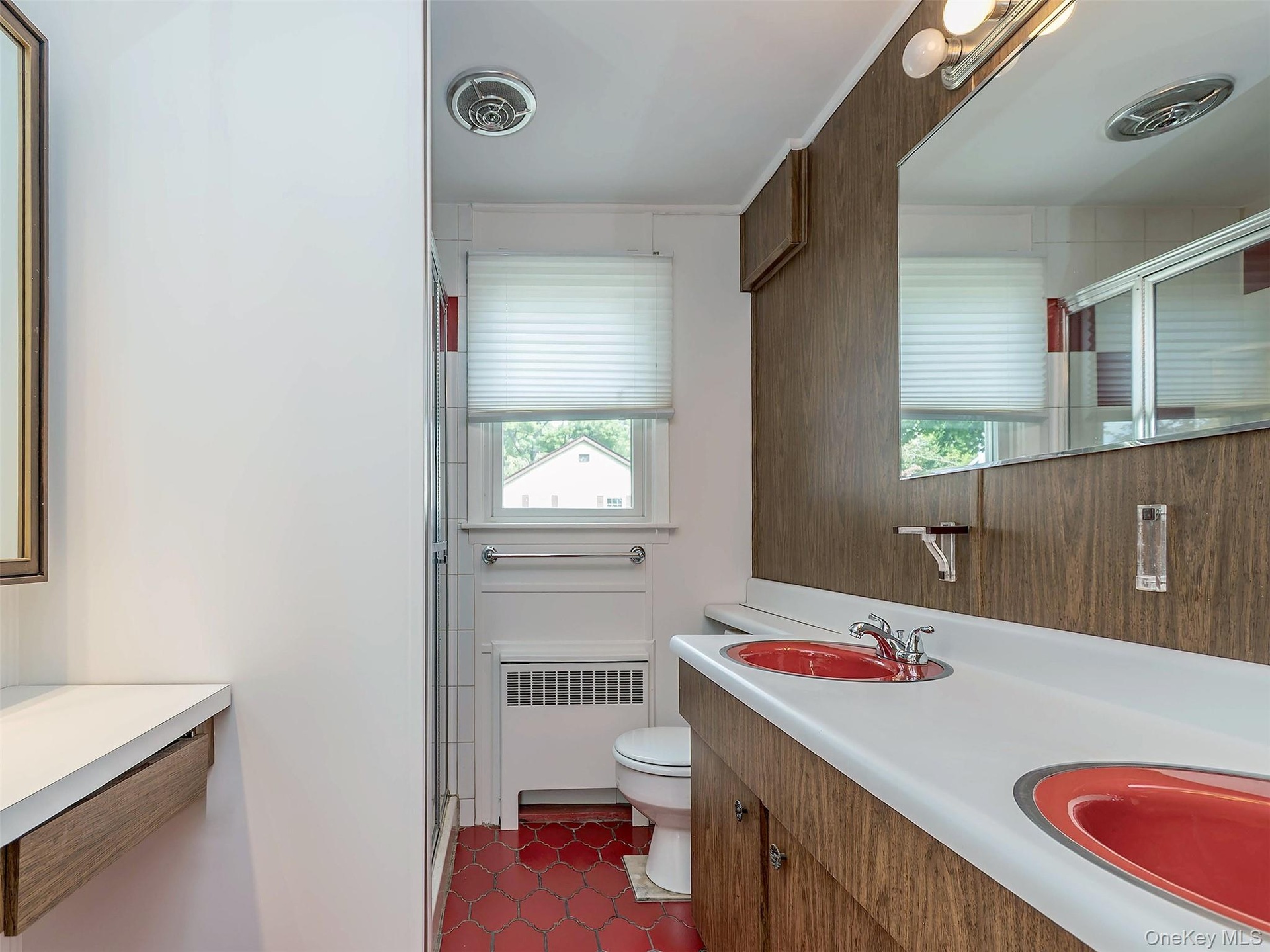 2nd floor: Bathroom with double red sinks, red tile floor with a built-in vanity.