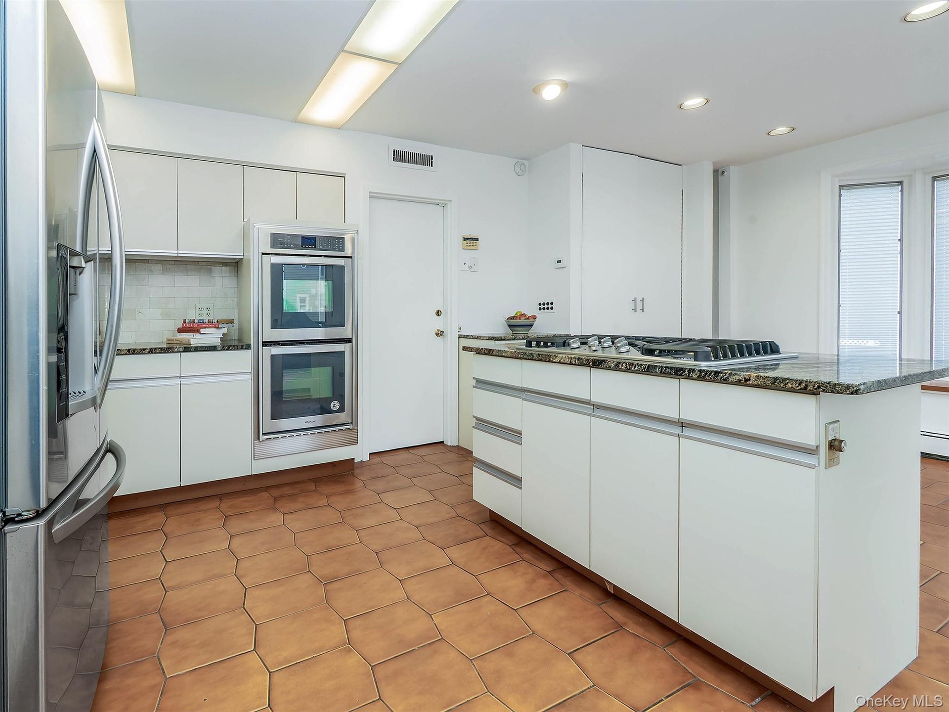 Door next to the double oven leads to the garage.