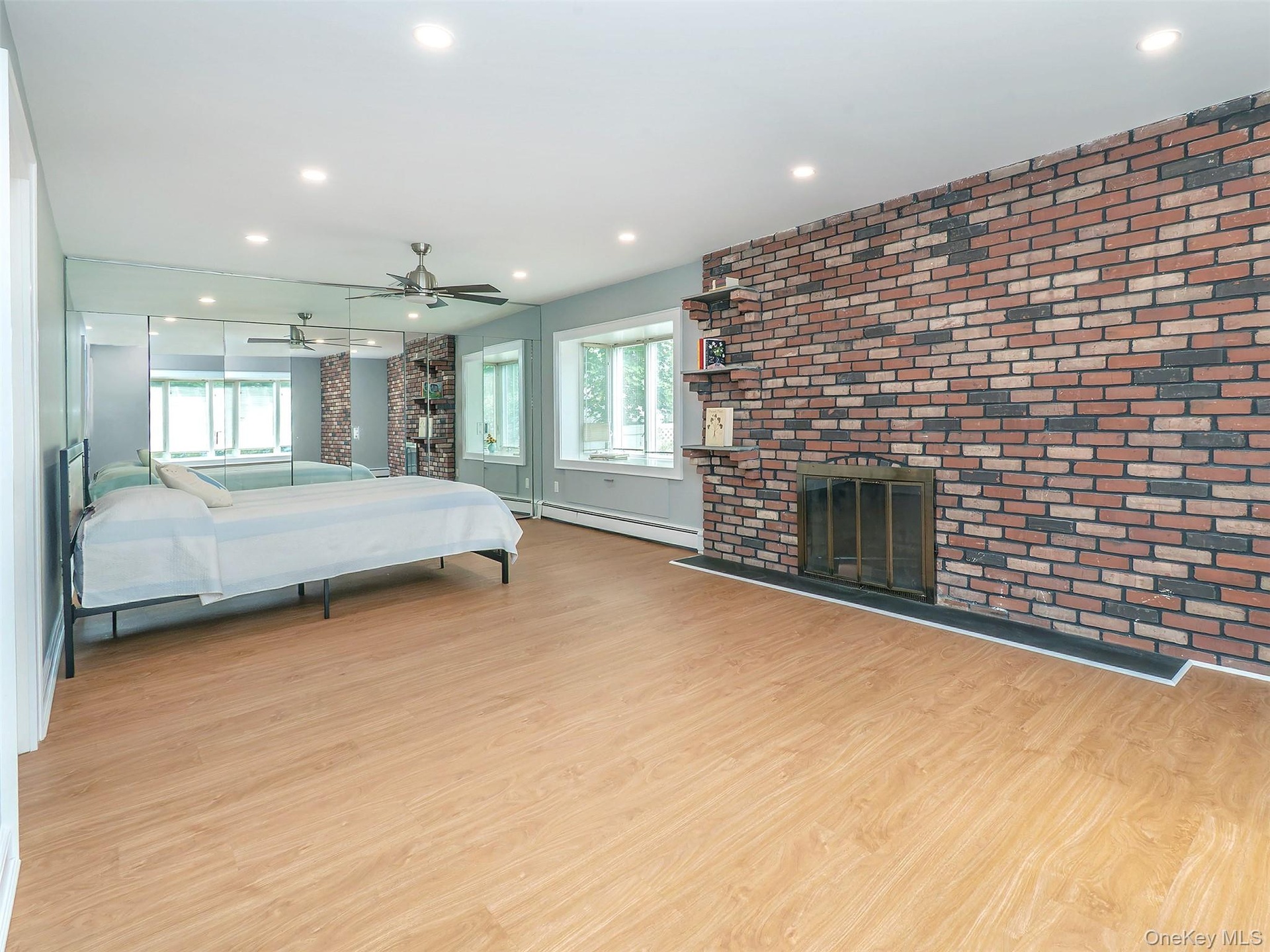 1st floor: Primary bedroom if you like with mirrored wall of closets. Bay window with storage.