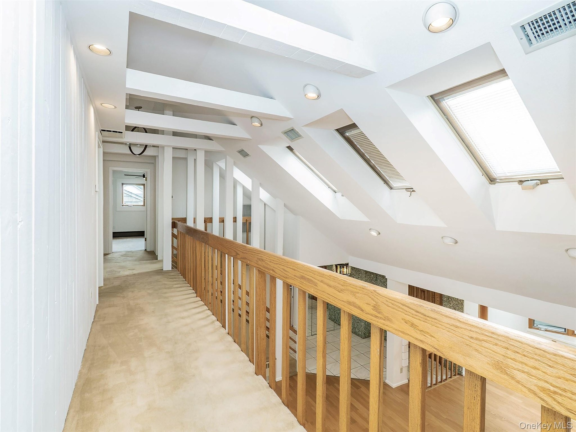 2nd floor: open hallway/balcony.  4 skylights. Carpeted floors.