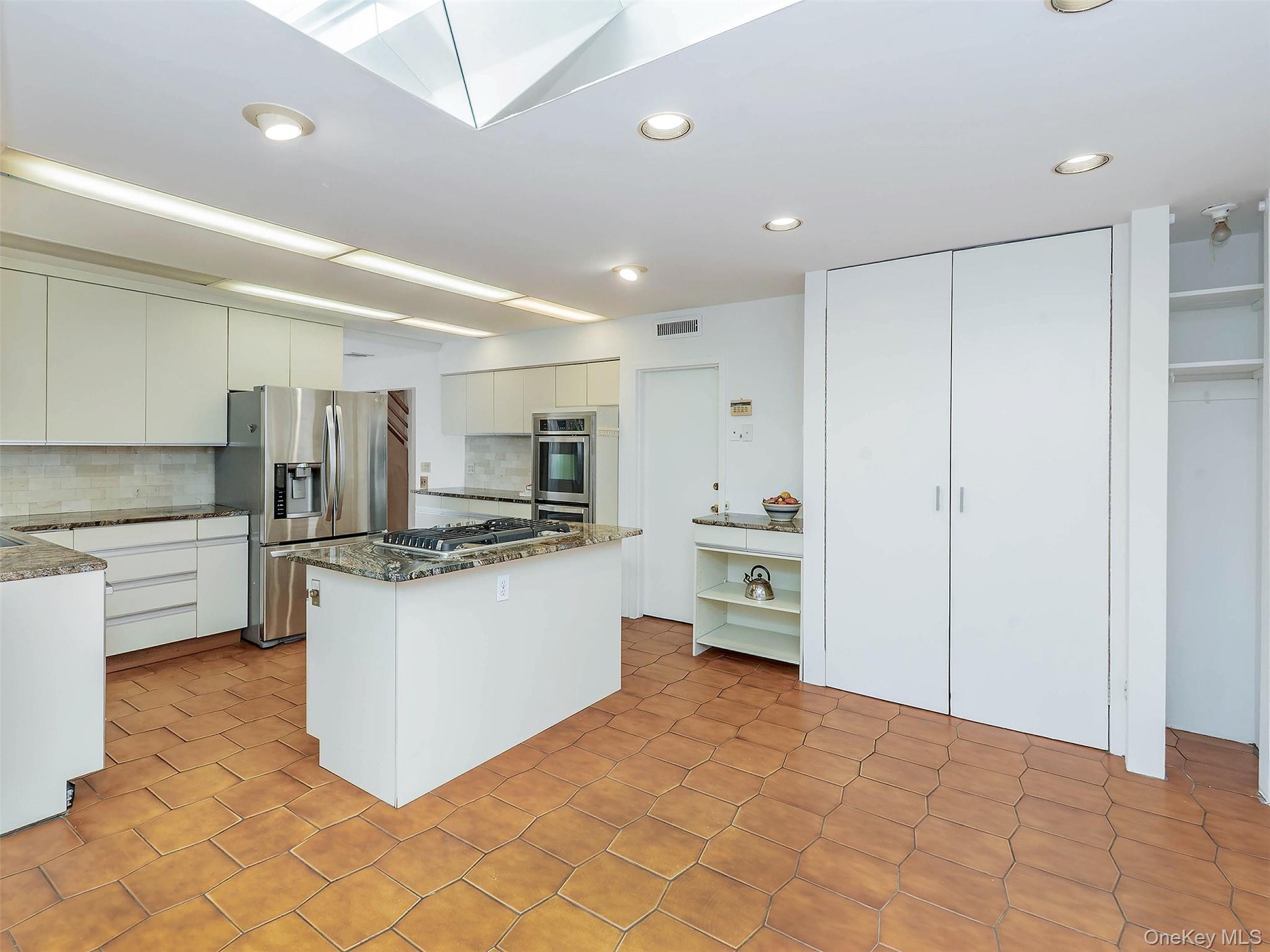 The is a pantry behind the double white doors.  Plenty of storage in this kitchen.