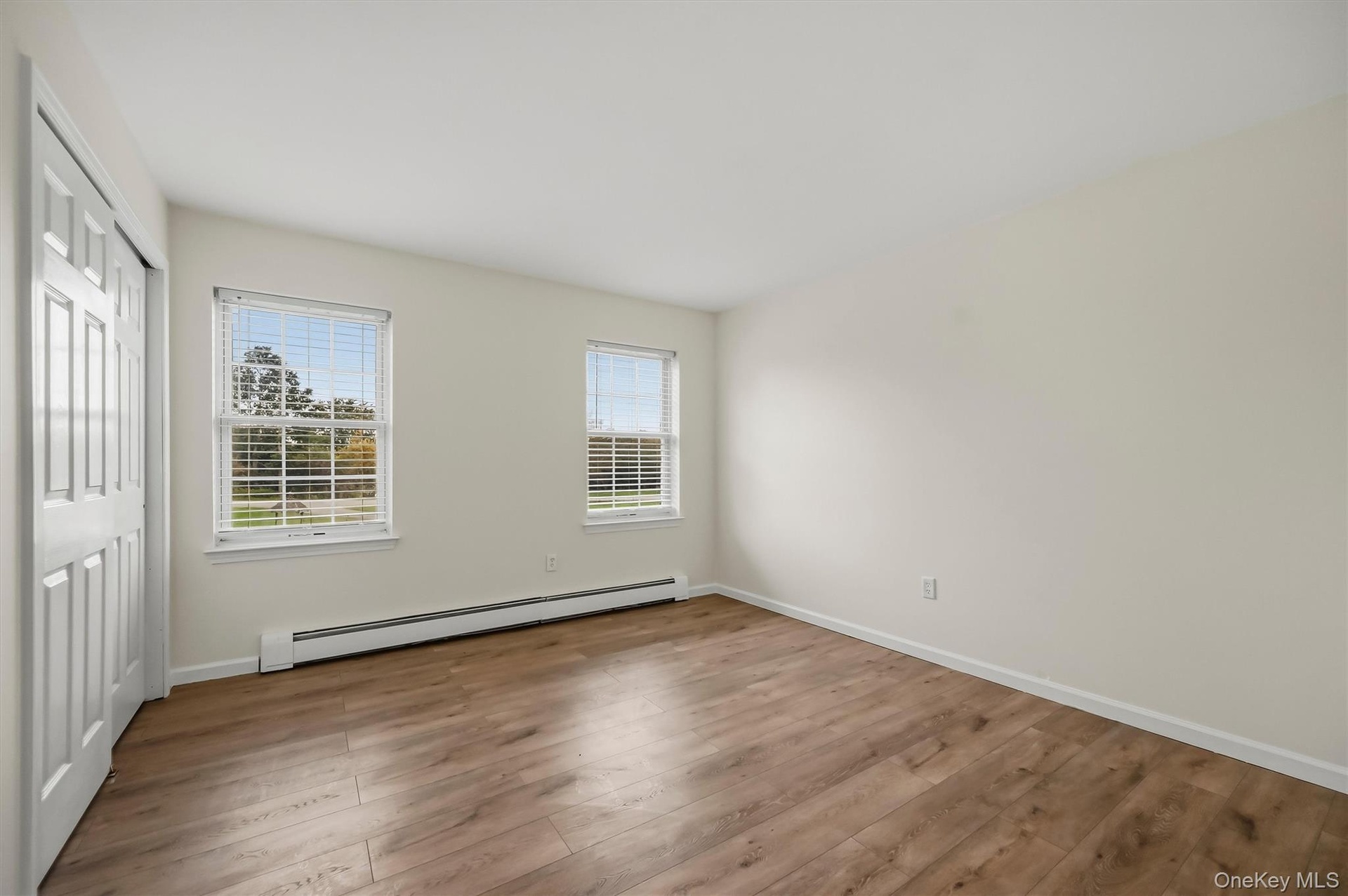 Two exposures bring natural light into this generously sized fourth bedroom.