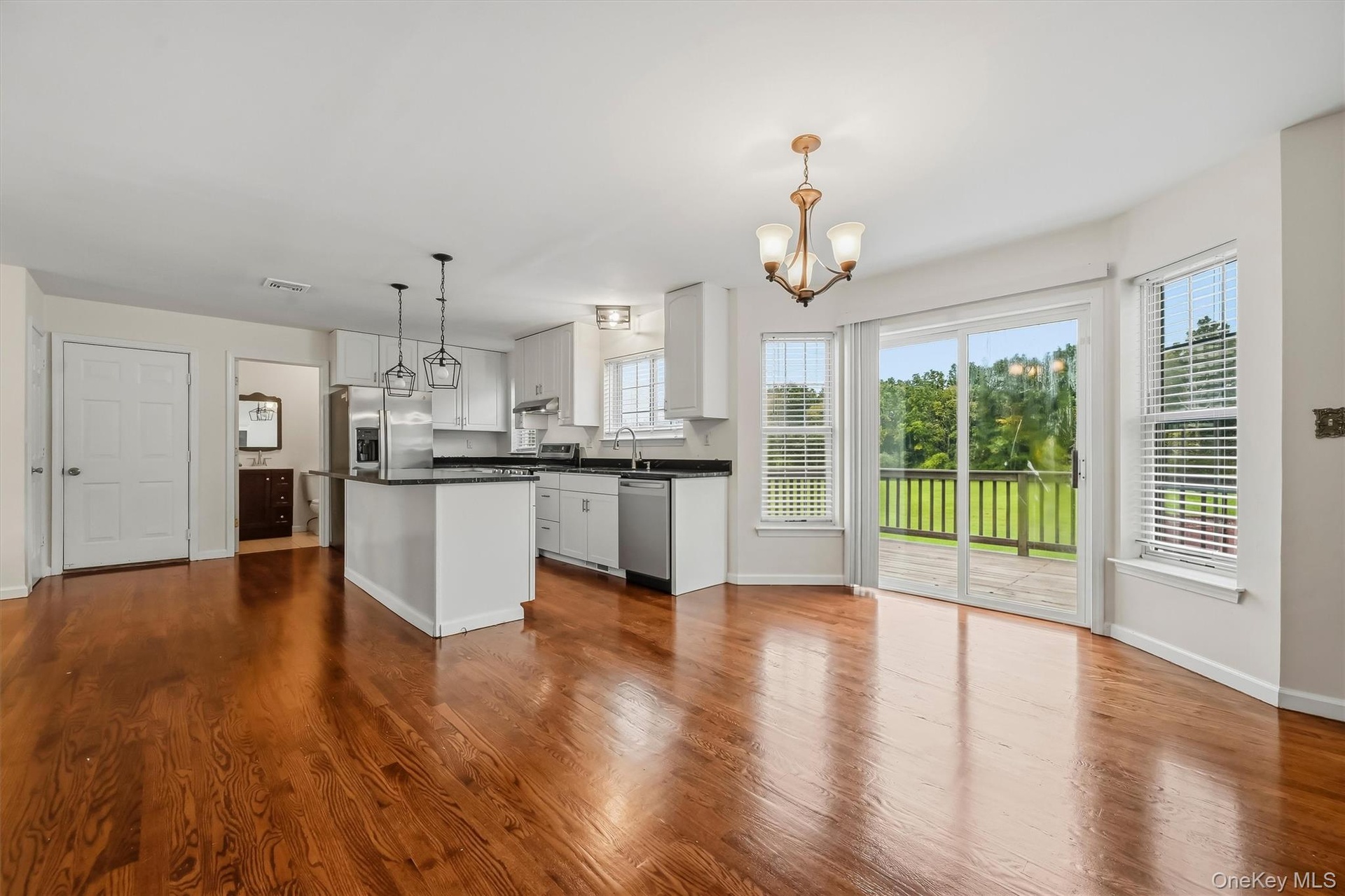 The kitchen opens directly into the dining area, with easy access to the deck and backyard beyond.