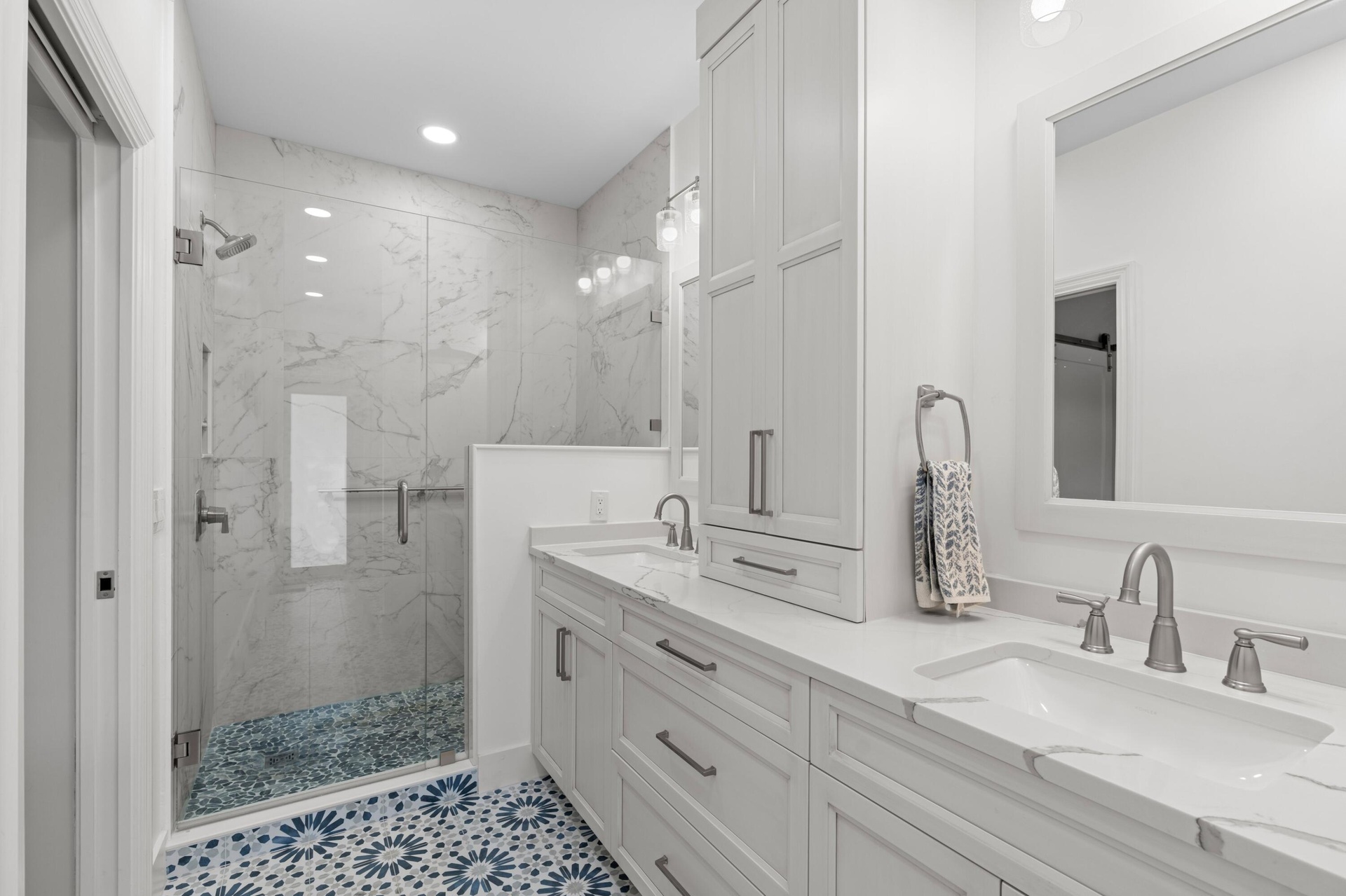 Completely remodeled primary bath w/walk in shower, custom dual vanities and beautiful tile work