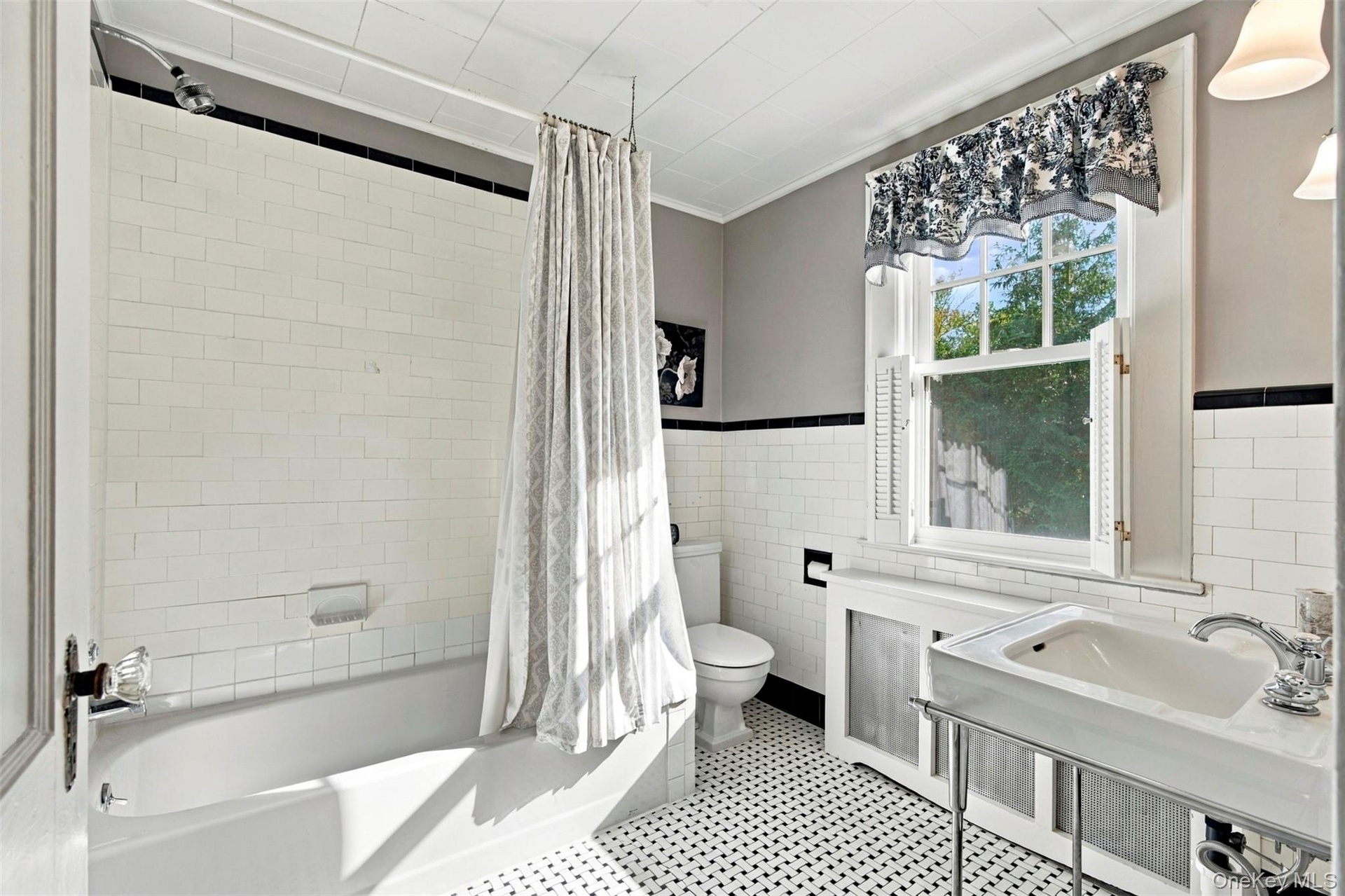Classic black & white tiling and pedestal sink.