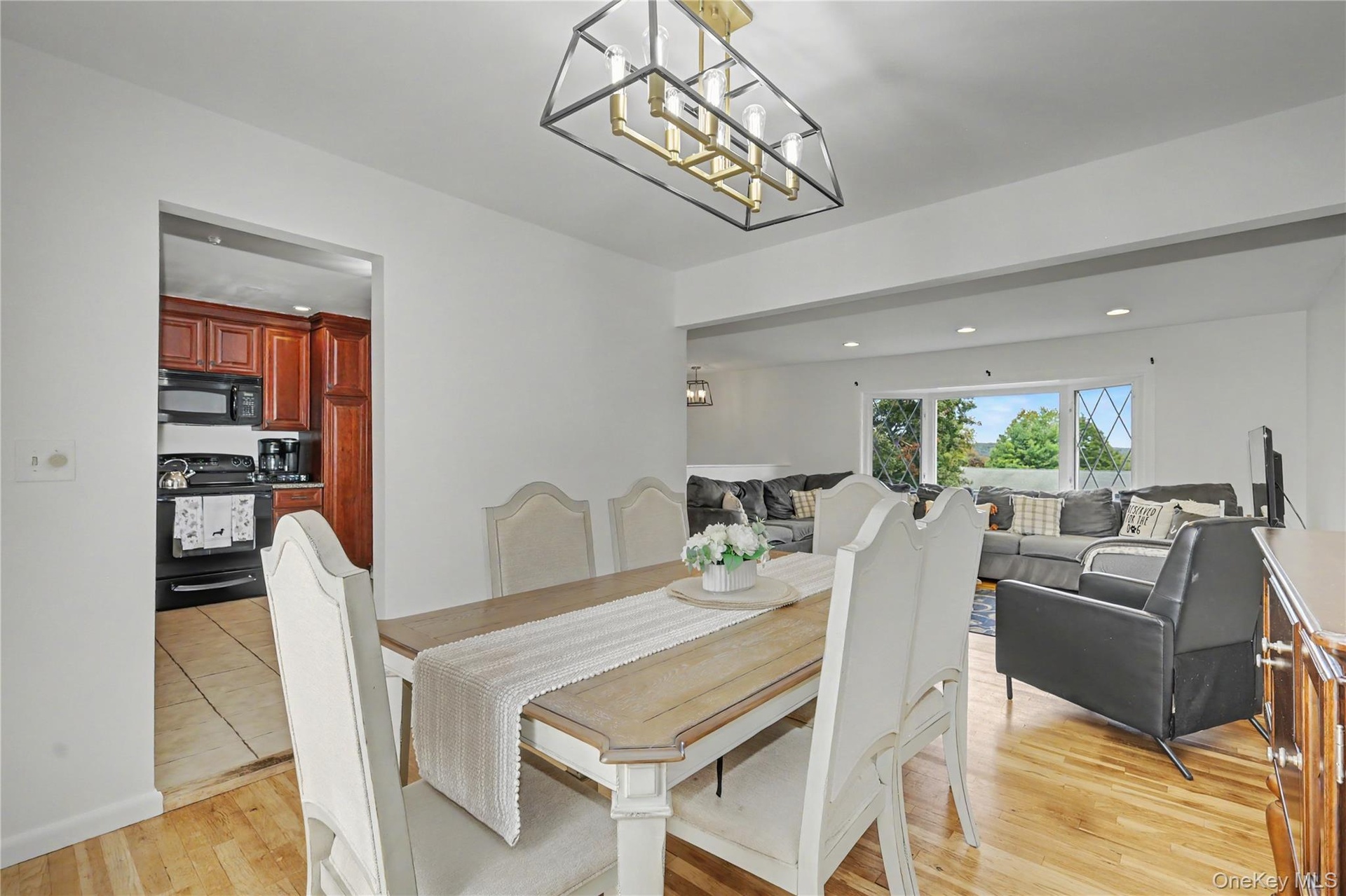 Cheerful dining room with open floor plan to living room