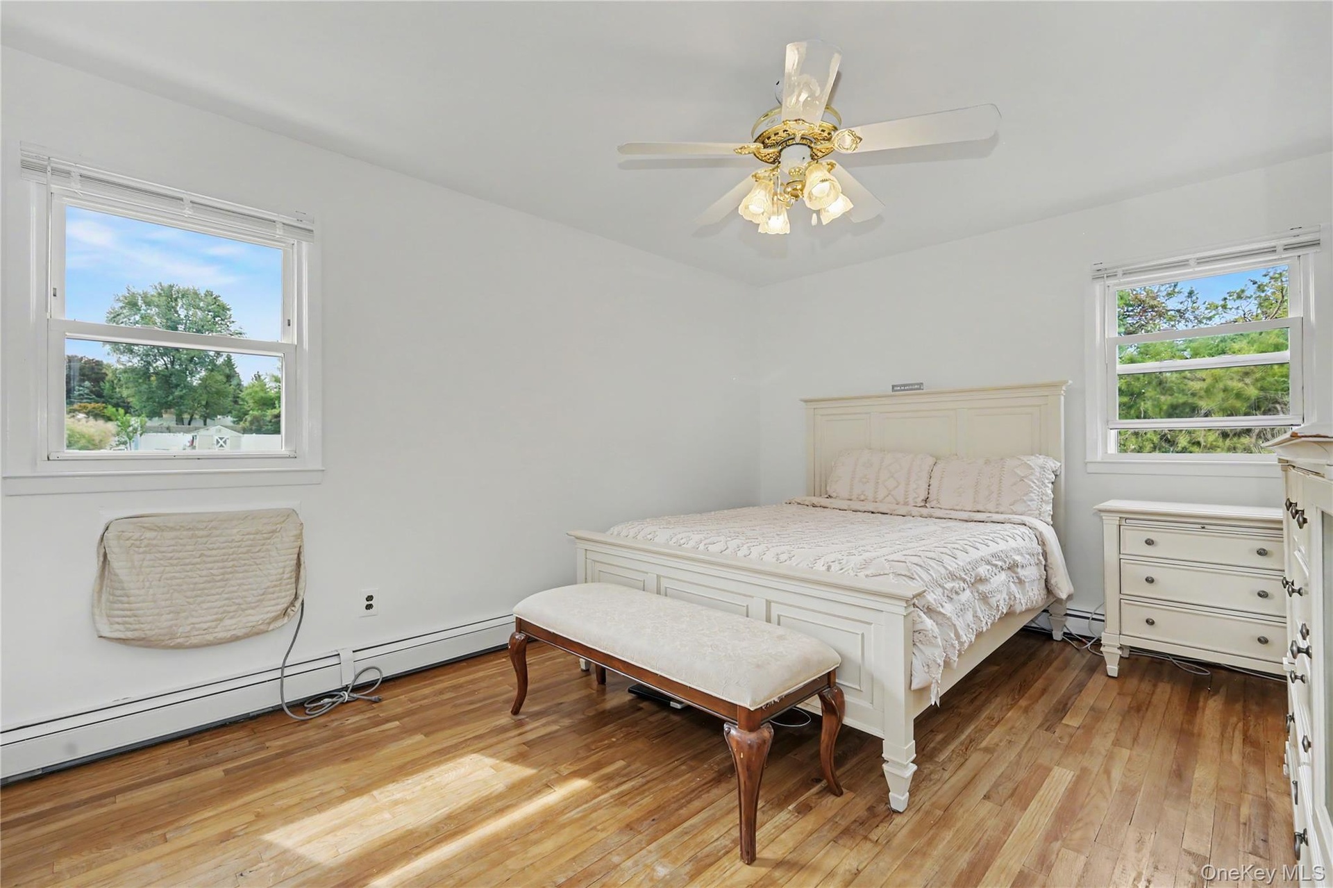 Substantially sized primary bedroom with great natural light and ceiling fan