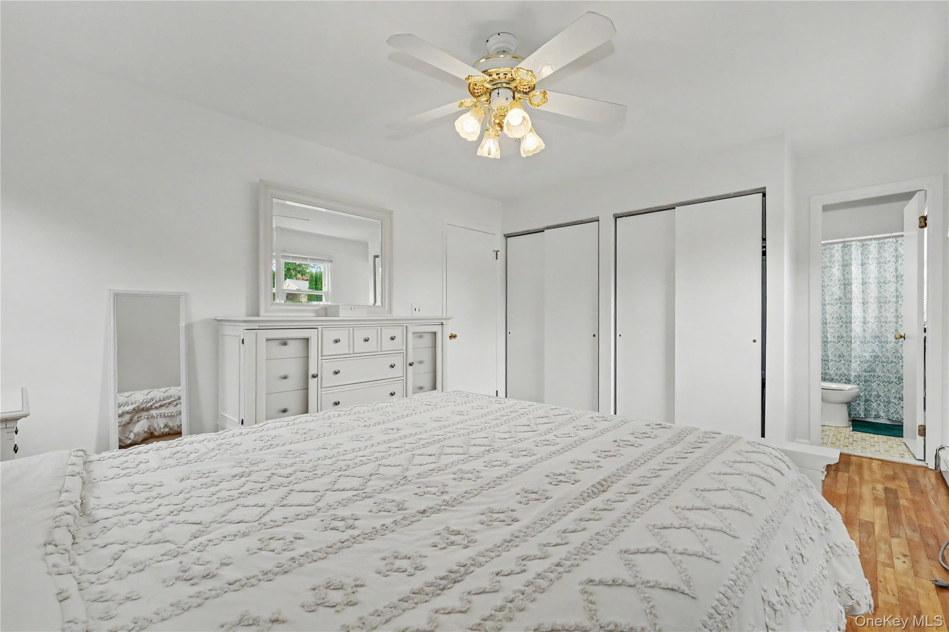 Substantially sized primary bedroom with his and hers closets