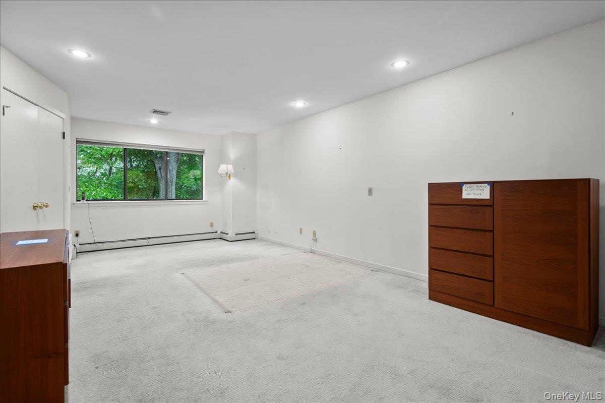 View from the door into the primary suite, large windows letting in natural light