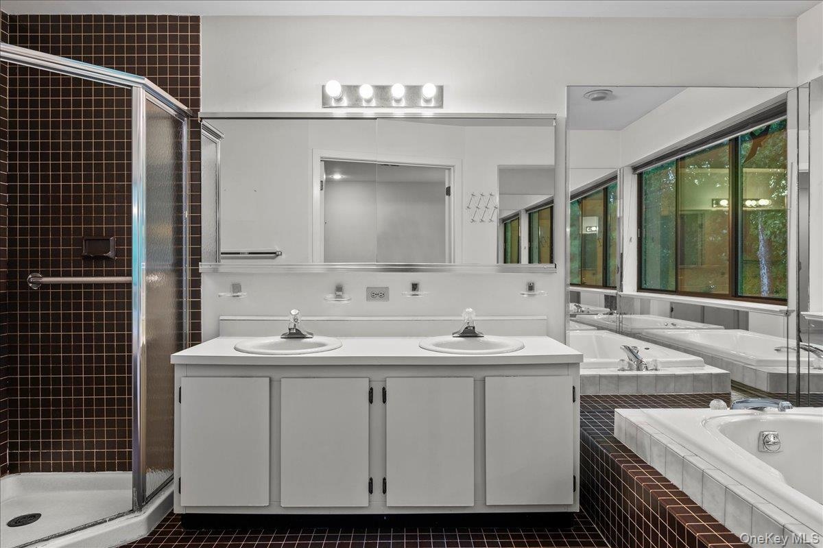 Double vanity, spa tub, and walk in shower