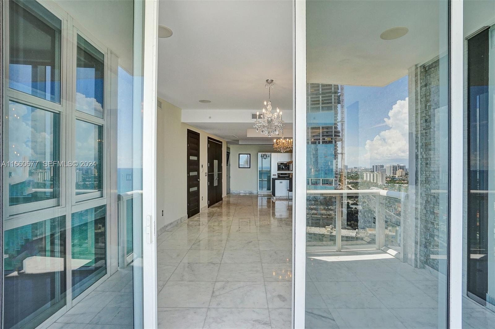 VIEW FROM BALCONY TO LIVING ROOM, ENTRANCE, KITCHEN