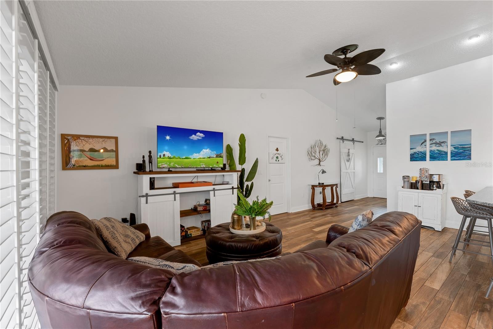 The door to the Owner's suite is off the Living room and the sliding barn door in the foyer conceals a coat closet and additional storage.