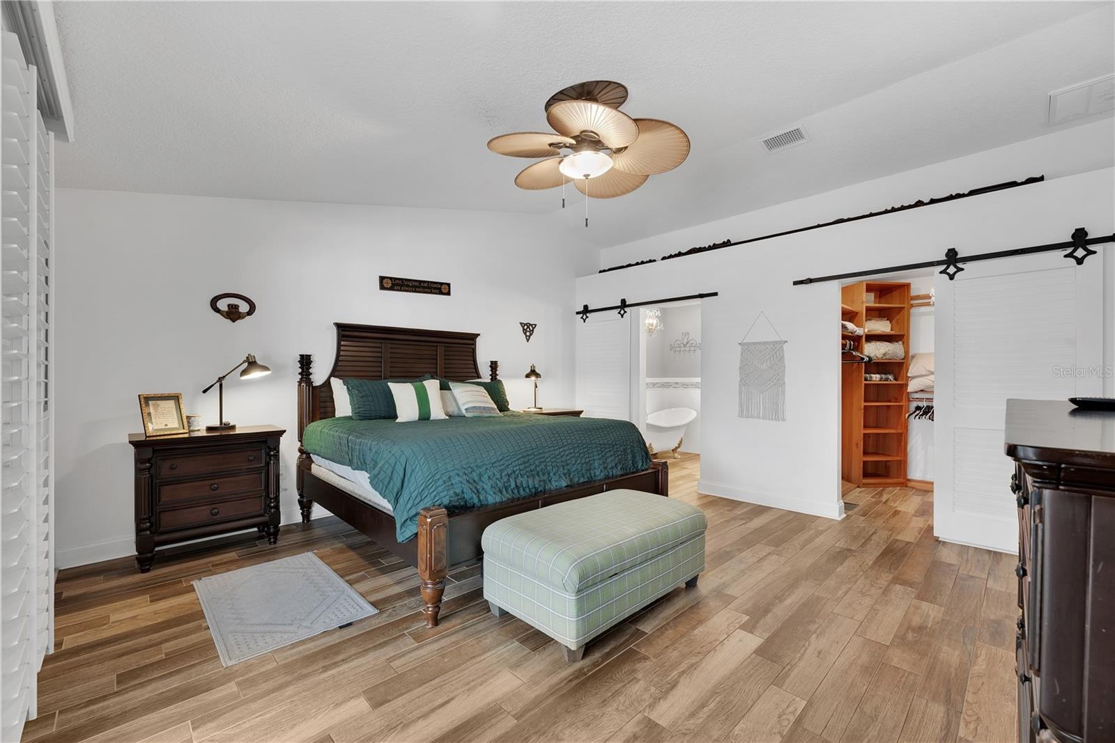 The cathedral ceiling and dual sliding barn doors give a charming vibe.