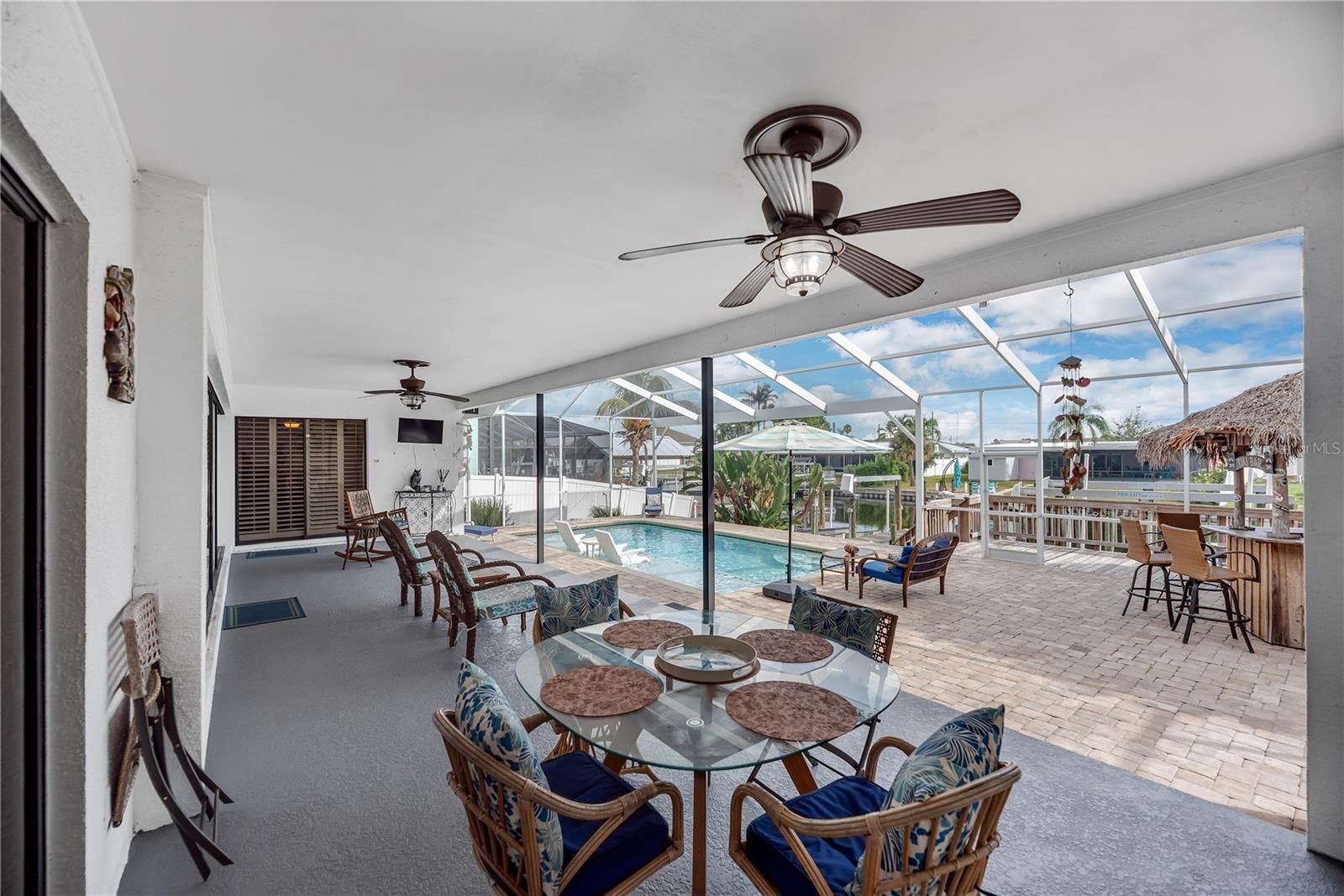 The spacious covered area provides plenty of shade and protection from Florida’s sun and passing showers, making outdoor enjoyment comfortable year-ro