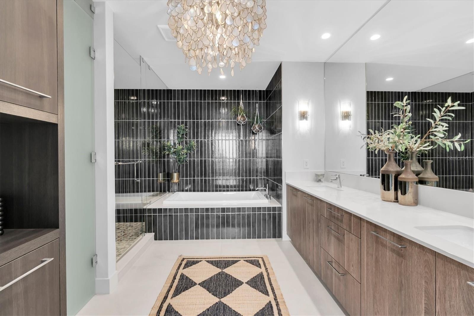 Modern ensuite bath with stone finishes.