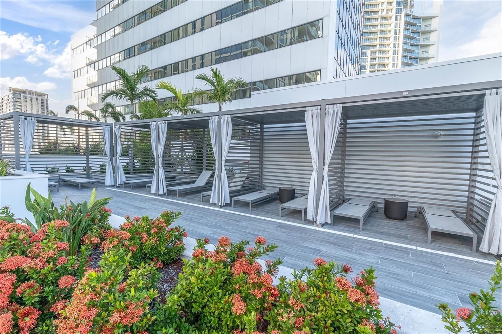 Private resort poolside cabanas with seating.