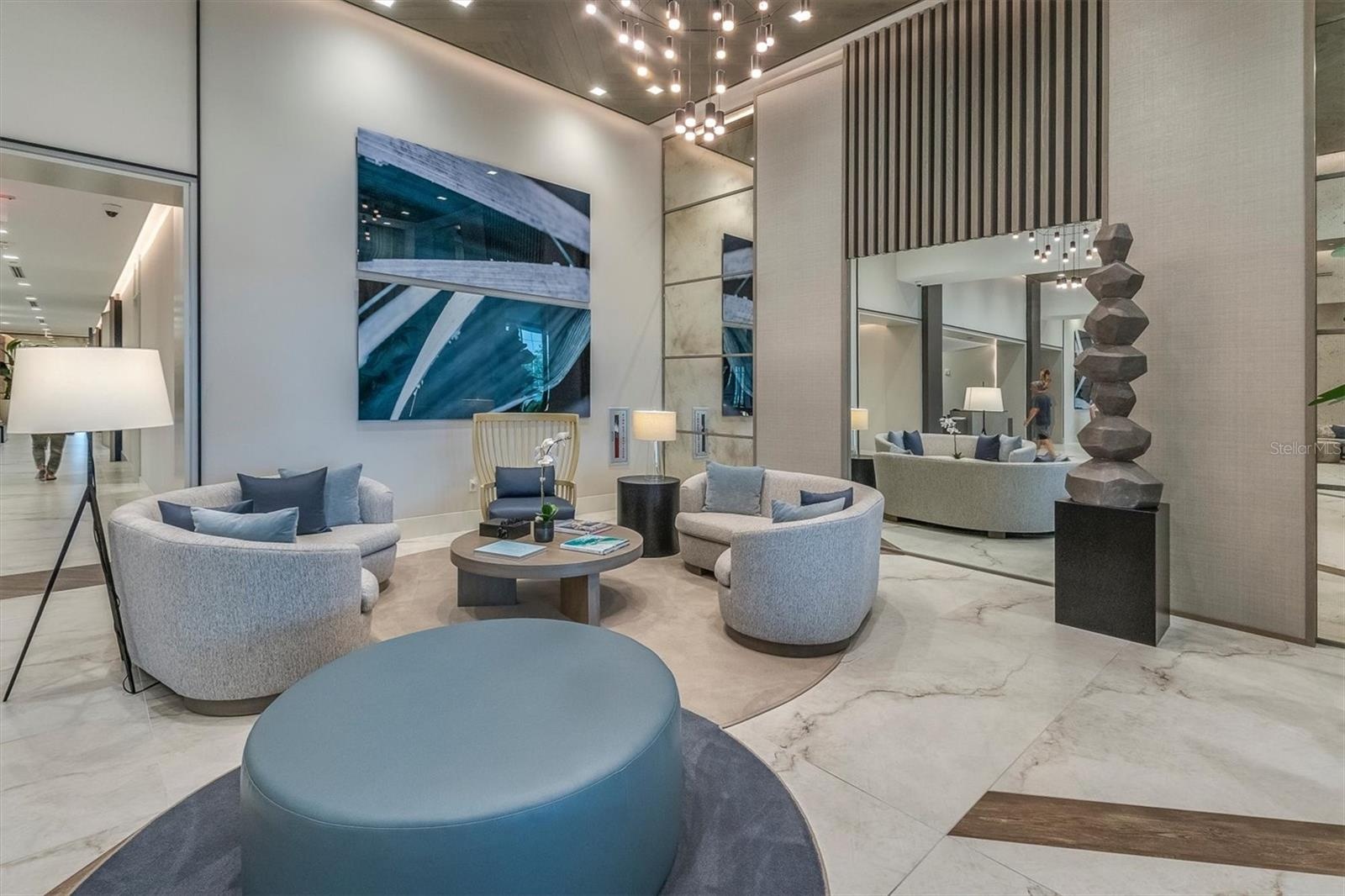Grand double-height lobby with concierge desk.