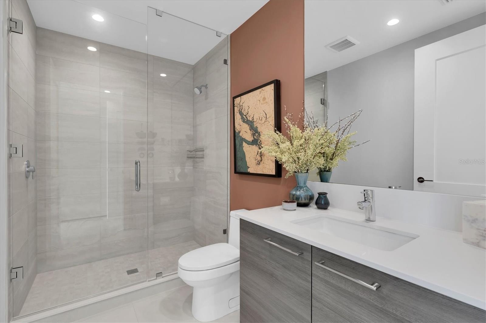 Guest ensuite bath with glass shower.