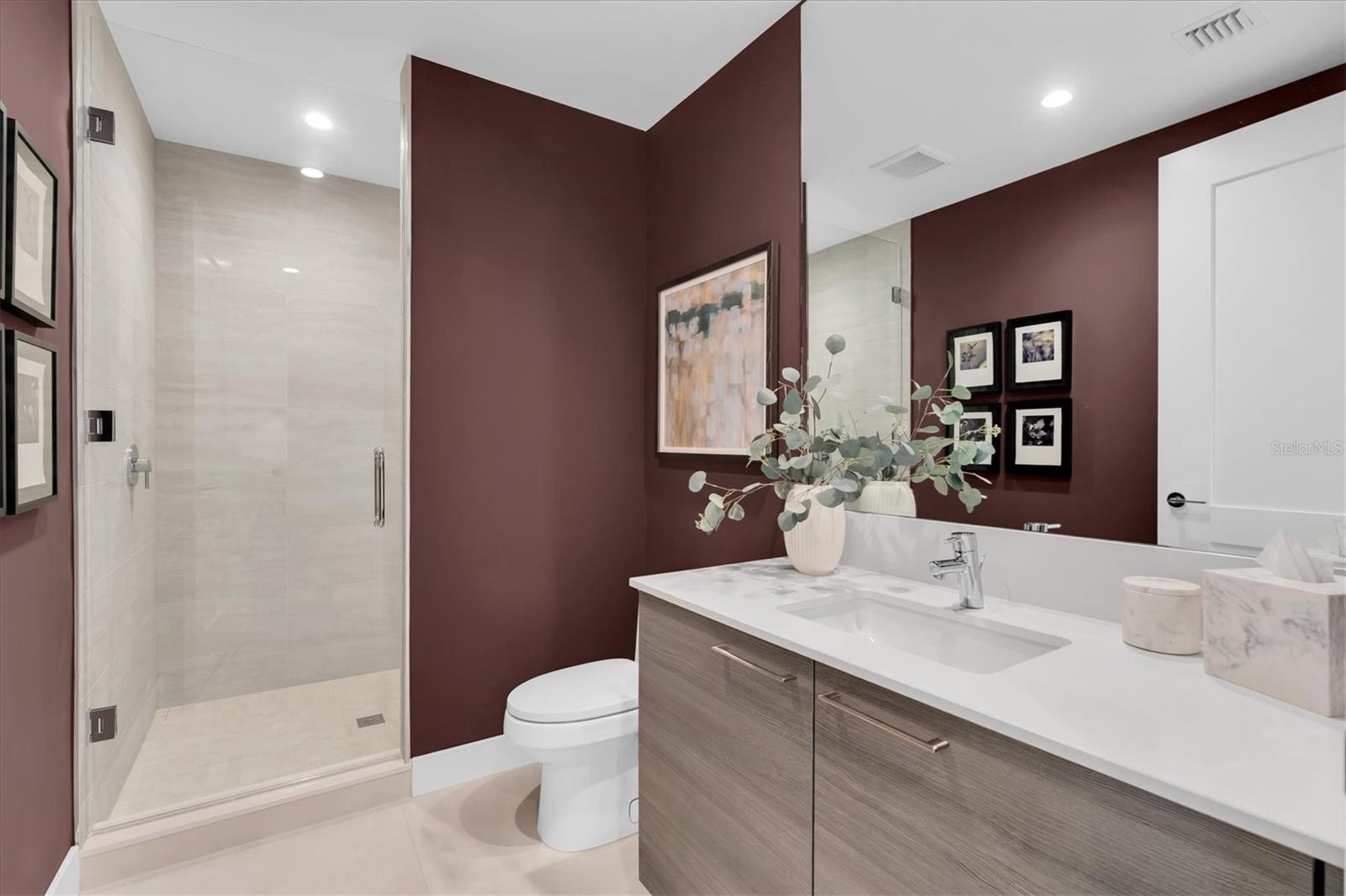 Stylish full guest bath with glass shower.