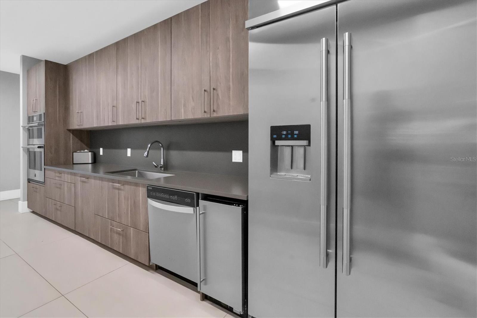 Event room kitchen outfitted for catering preparation with outdoor grill and seating