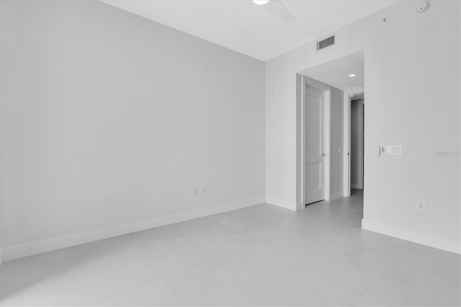 Generous guest room with modern detailing.