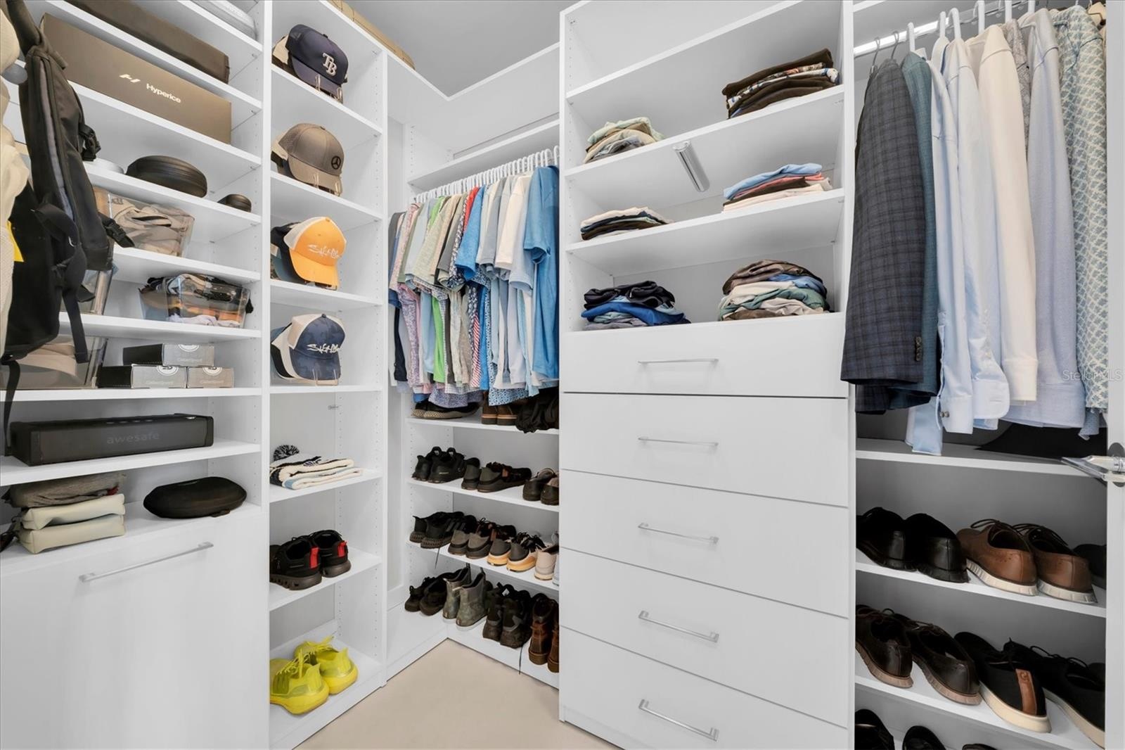 Expansive primary wardrobe with custom millwork.