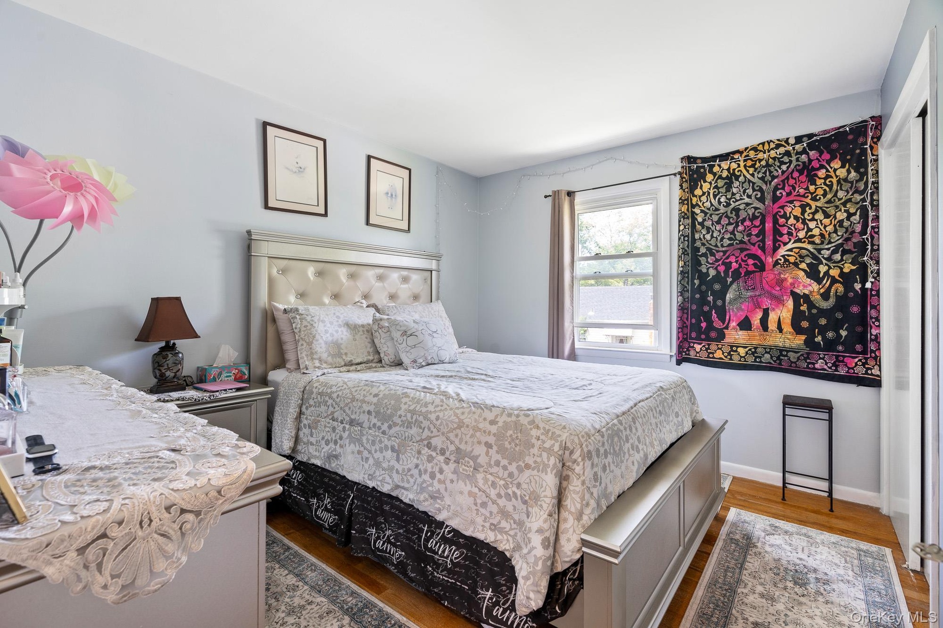 Bedroom featuring wood finished floors and baseboards
