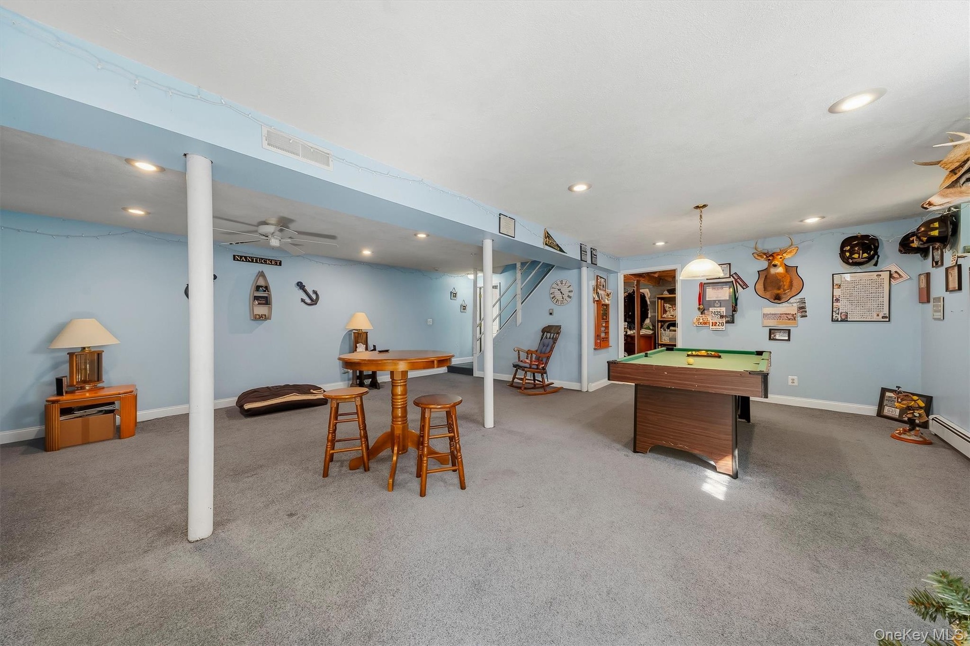Finished lower level with recessed lighting, carpet flooring, and a ceiling fan