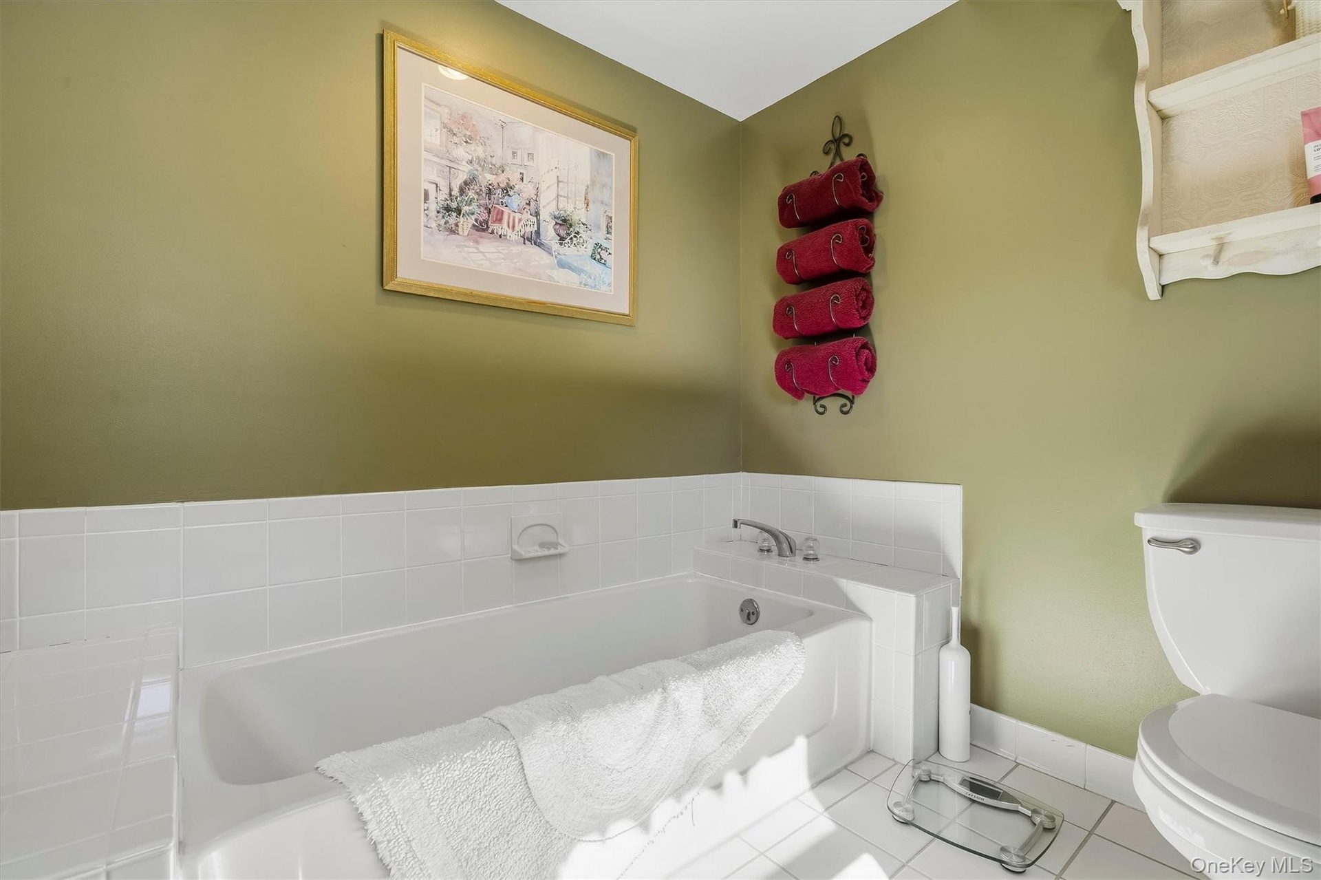 White tile flooring and bathtub surround