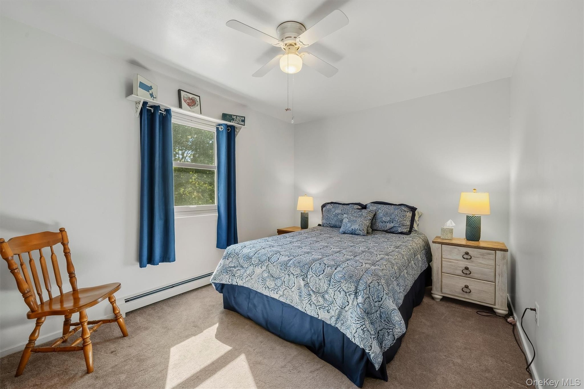 Recessed window with white trim, wall-to-wall carpeting, and a ceiling fan with integrated lighting