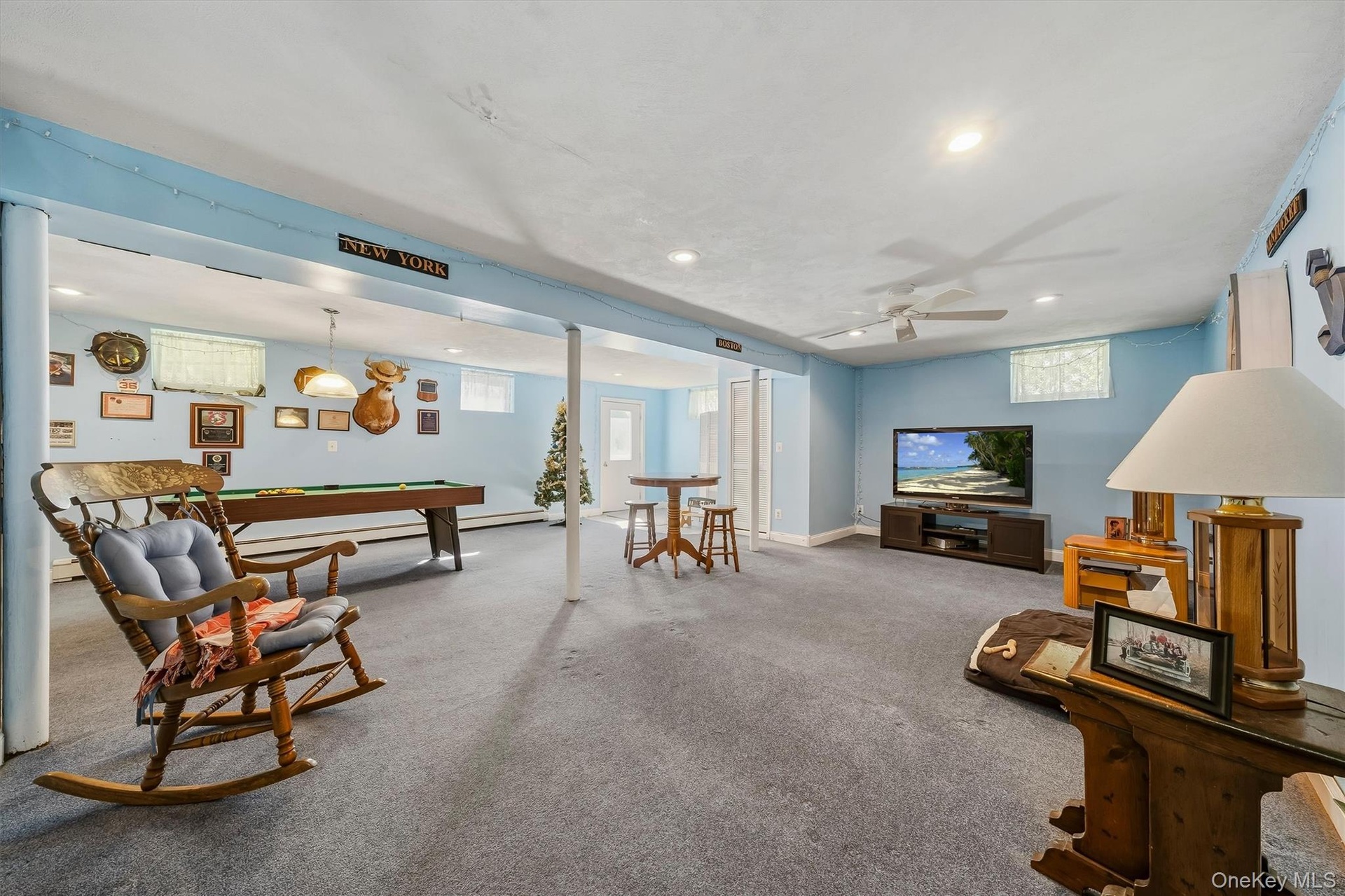 Spacious finished basement with recessed lighting, ceiling fan, and carpeted flooring