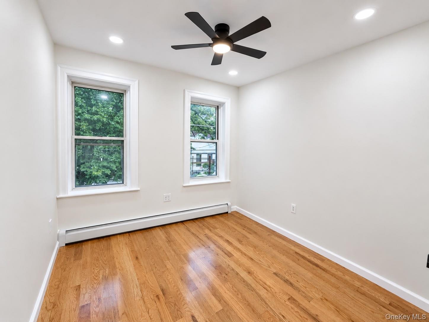 Hardwood flooring, recessed lighting, and a ceiling fan