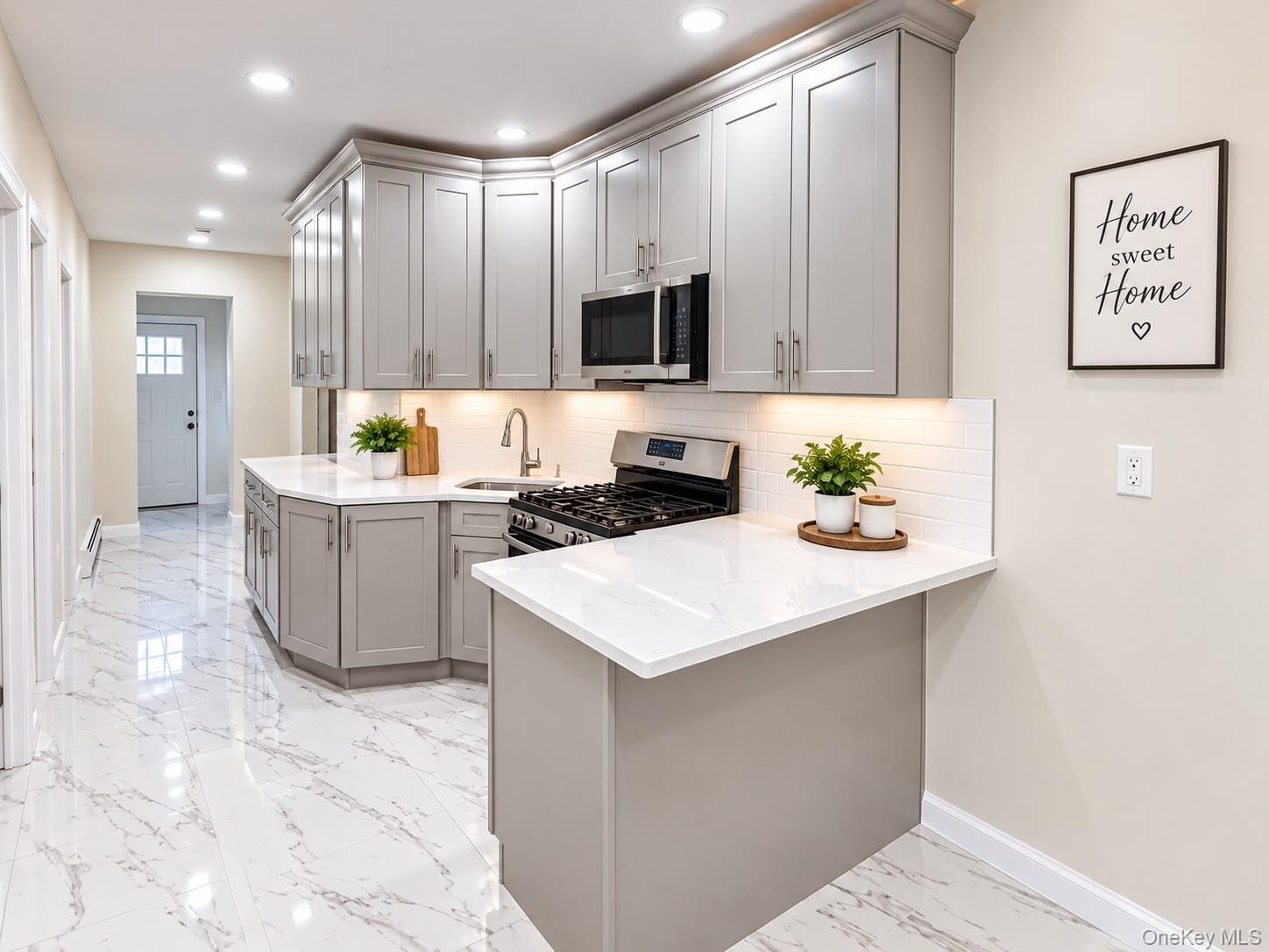 Kitchen featuring light gray cabinetry, white countertops, tile flooring, stainless steel appliances, and recessed lighting