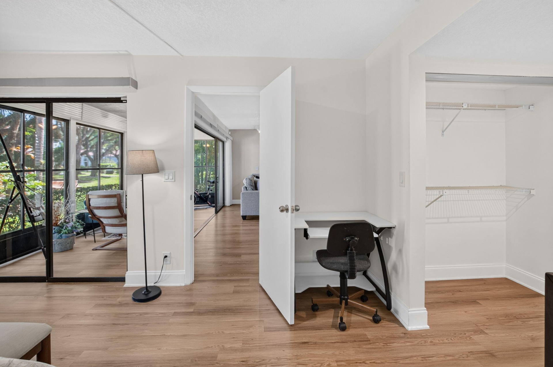 Wood-finish flooring throughout, with a desk area and wall closet