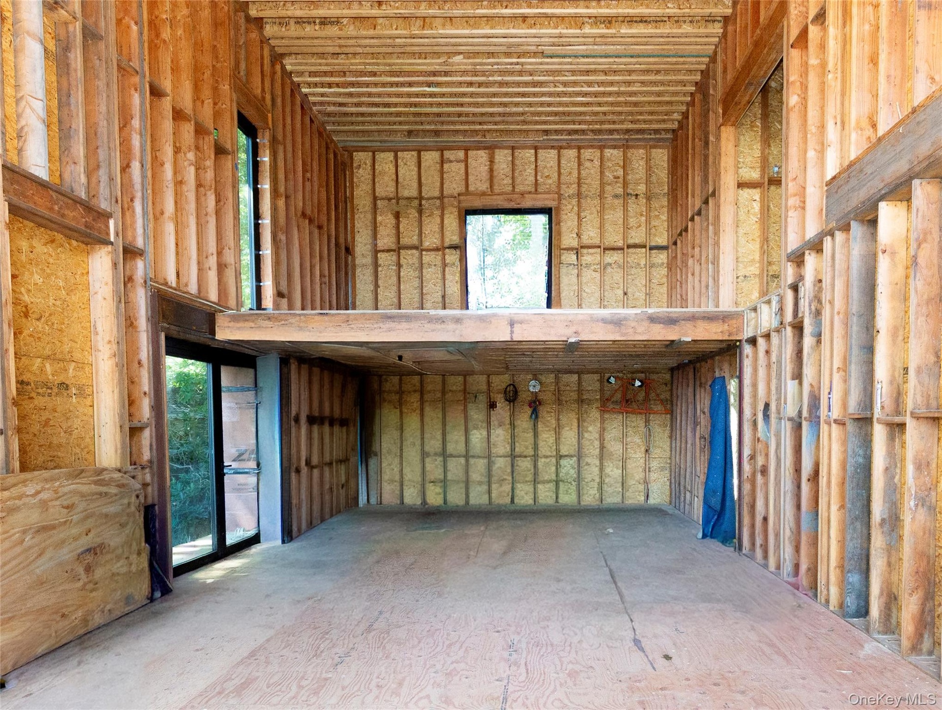 The kitchen planned around a back wall of cabinetry and appliances and a substantial island positioned in front. View of the loft above.