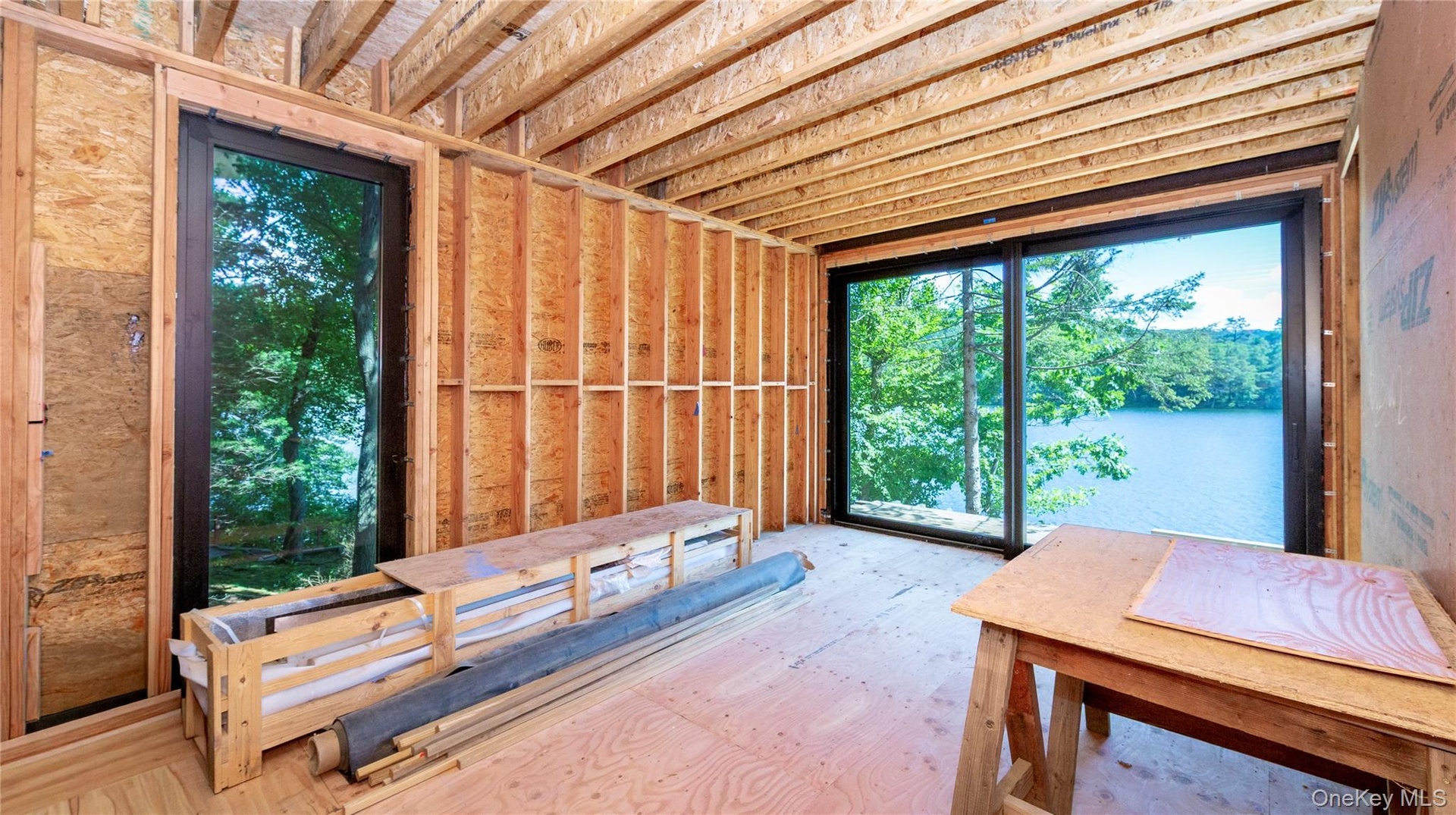 Primary bath behind with spectacular lake views through sliding glass doors.