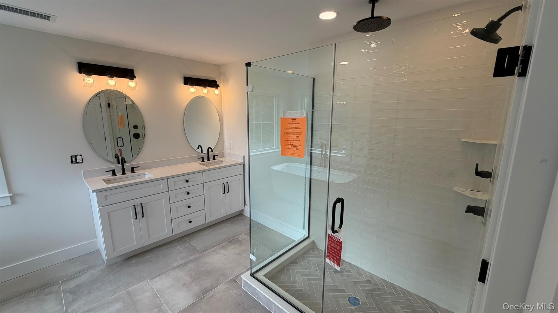 Additional view of the generous-spa like primary bath with newly glass enclosed walk in shower glass and tile.