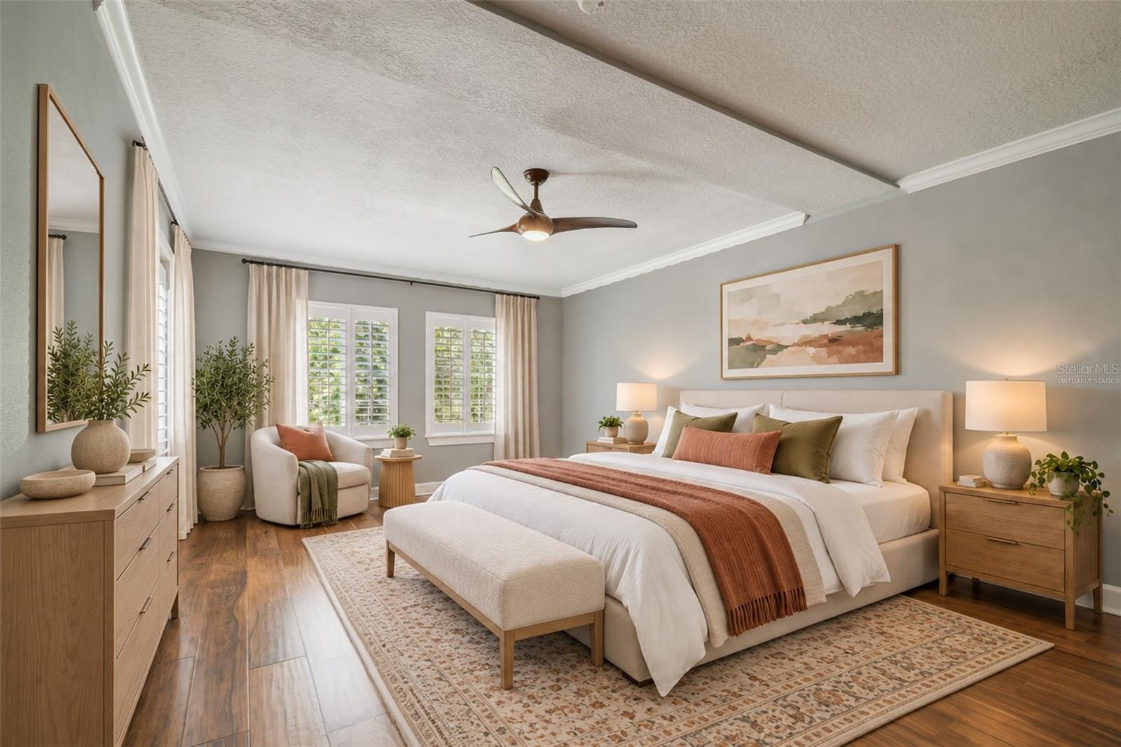 Virtually staged primary bedroom, easily accommodating a king size bed and end tables.