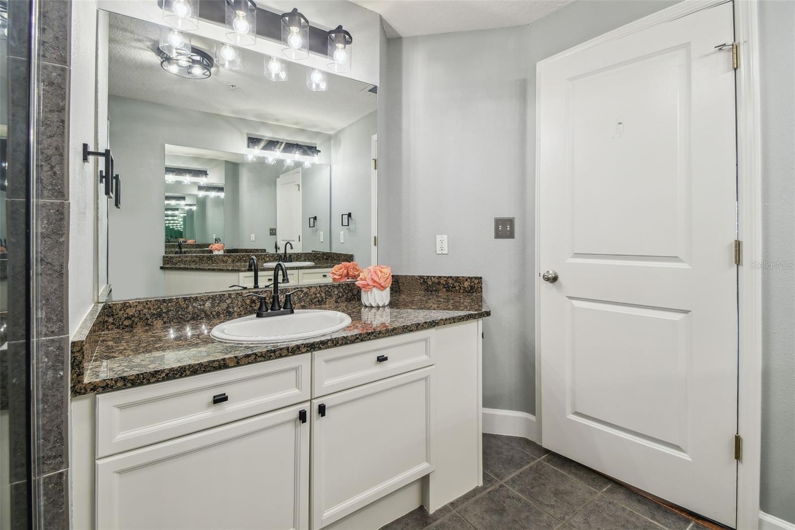 Primary bathroom with dual vanities.