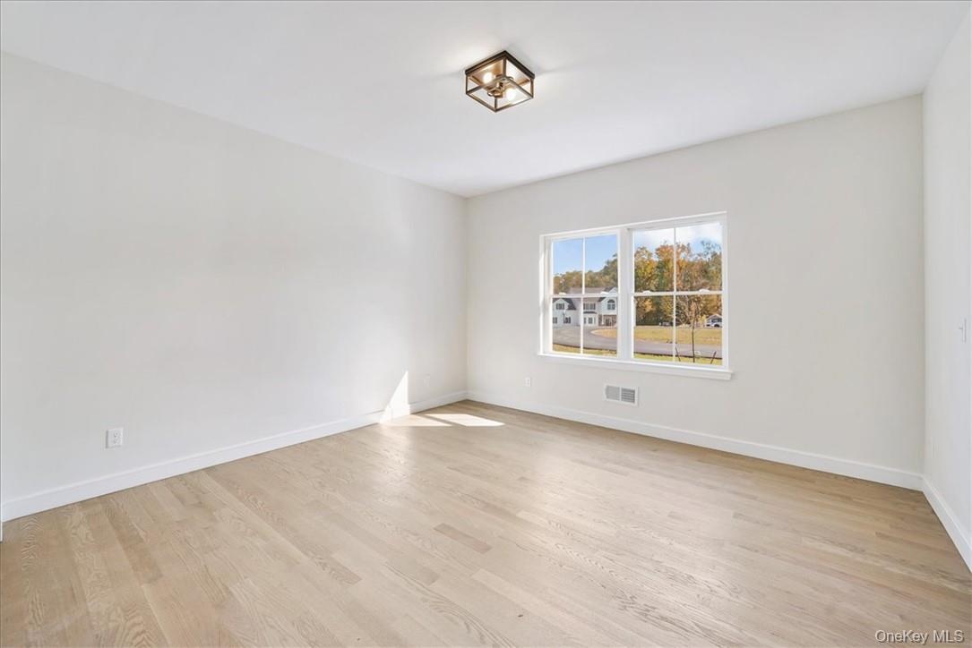 Empty room with light wood-type flooring