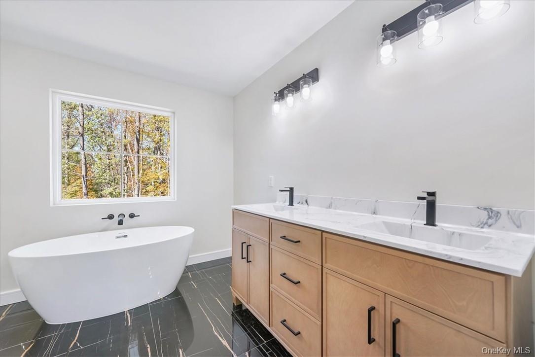 Bathroom featuring vanity and a bathtub