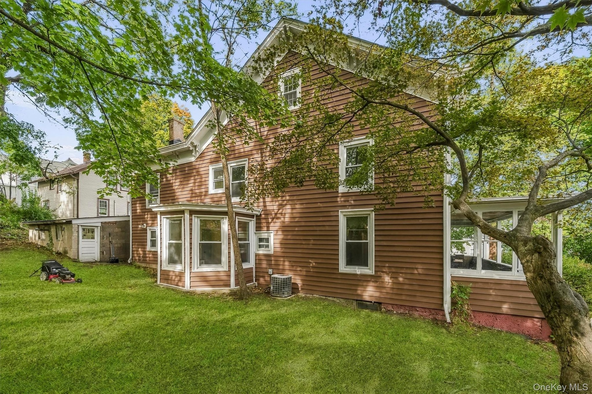 Brown clapboard siding with white trim