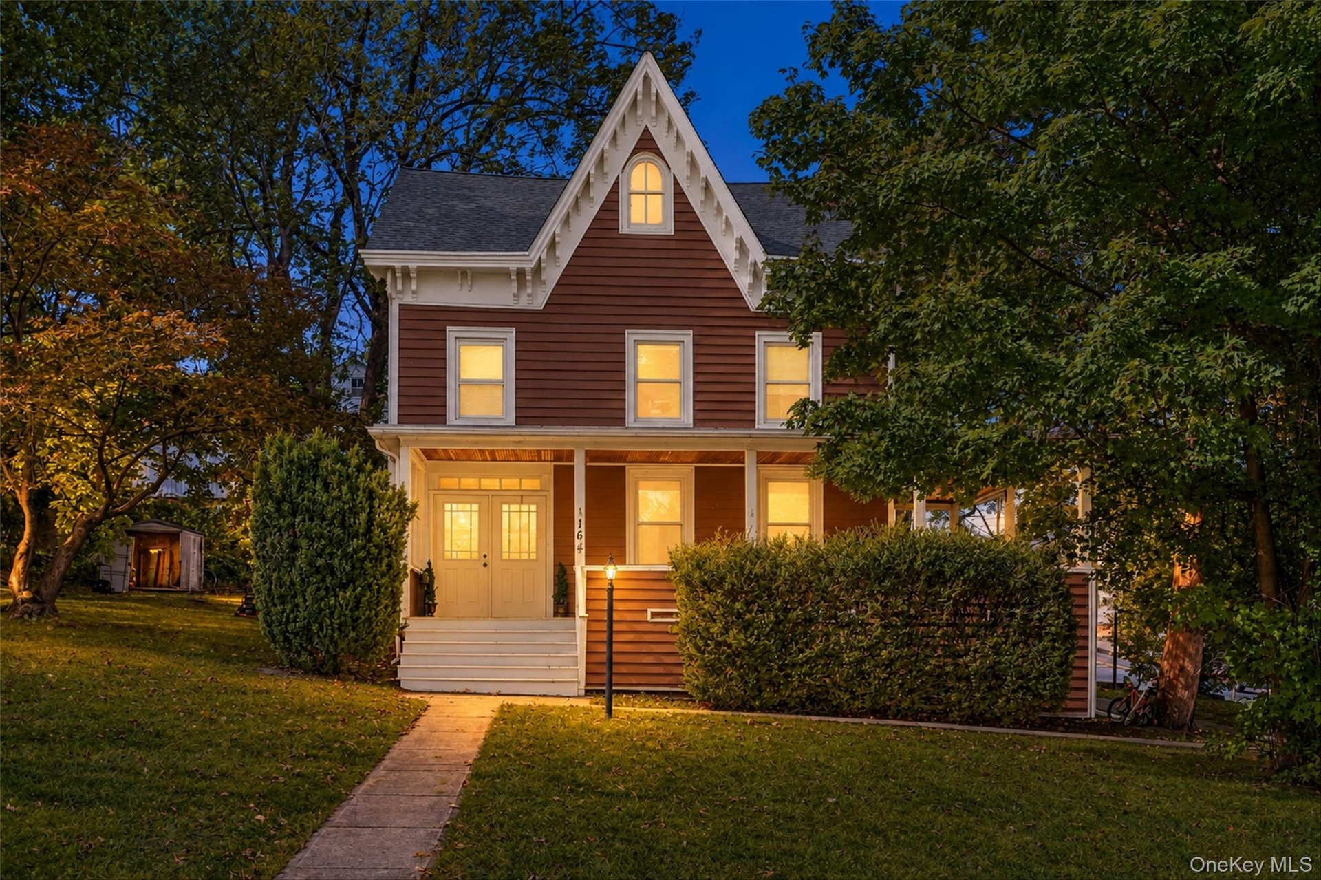 Architectural facade featuring a prominent gable roof and rich siding